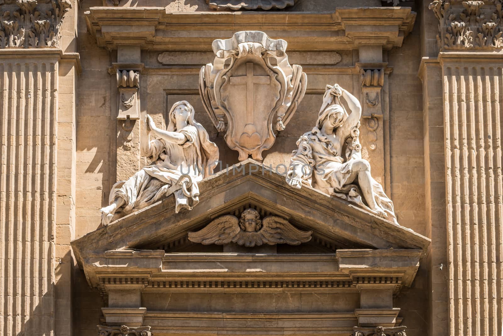 In the picture a marble statue of the Middle Ages showing two women, in the historic center of Florence.