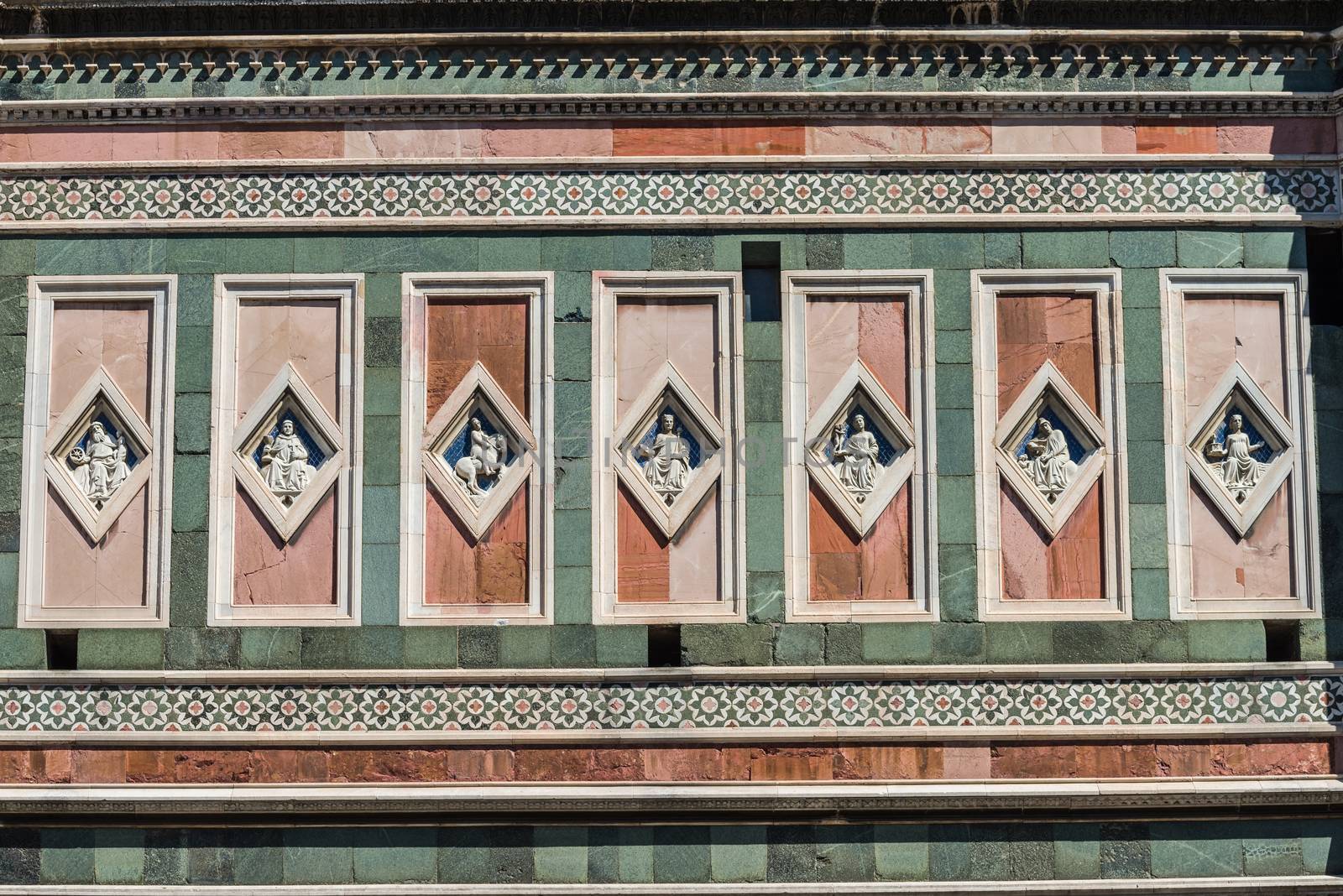 In the picture detail of the Basilica of Santa Maria del Fiore in Florence, a patterns of rectangular statues symmetrical.