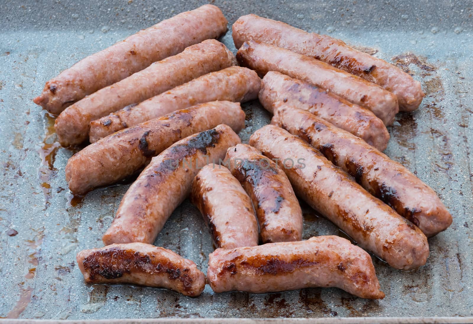 In the picture of the pork sausages are cooked on the grill ( barbecue) while.