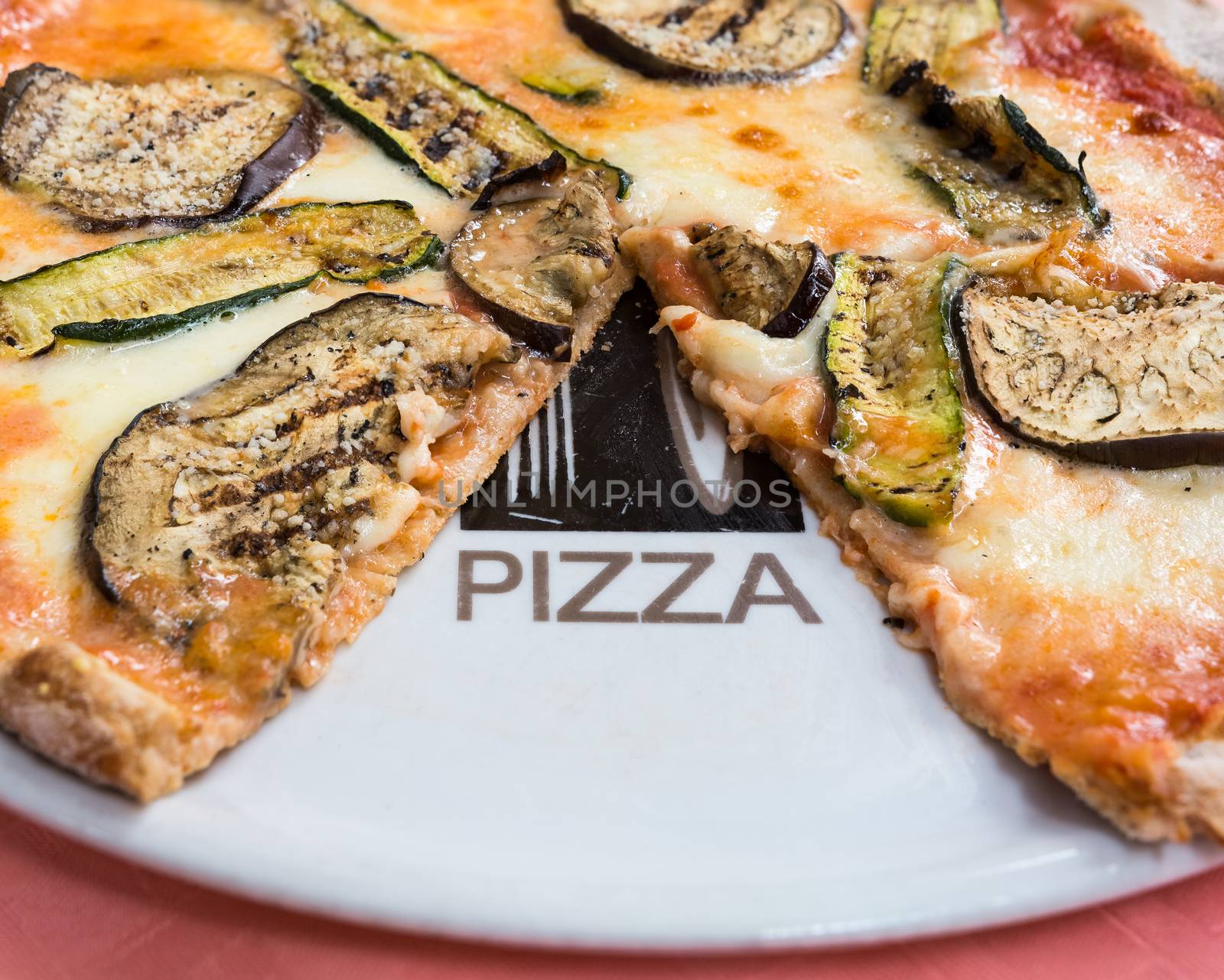 In the picture a whole wheat pizza with eggplant , zucchini , tomato and Neapolitan buffalo mozzarella.( Bufala campana)