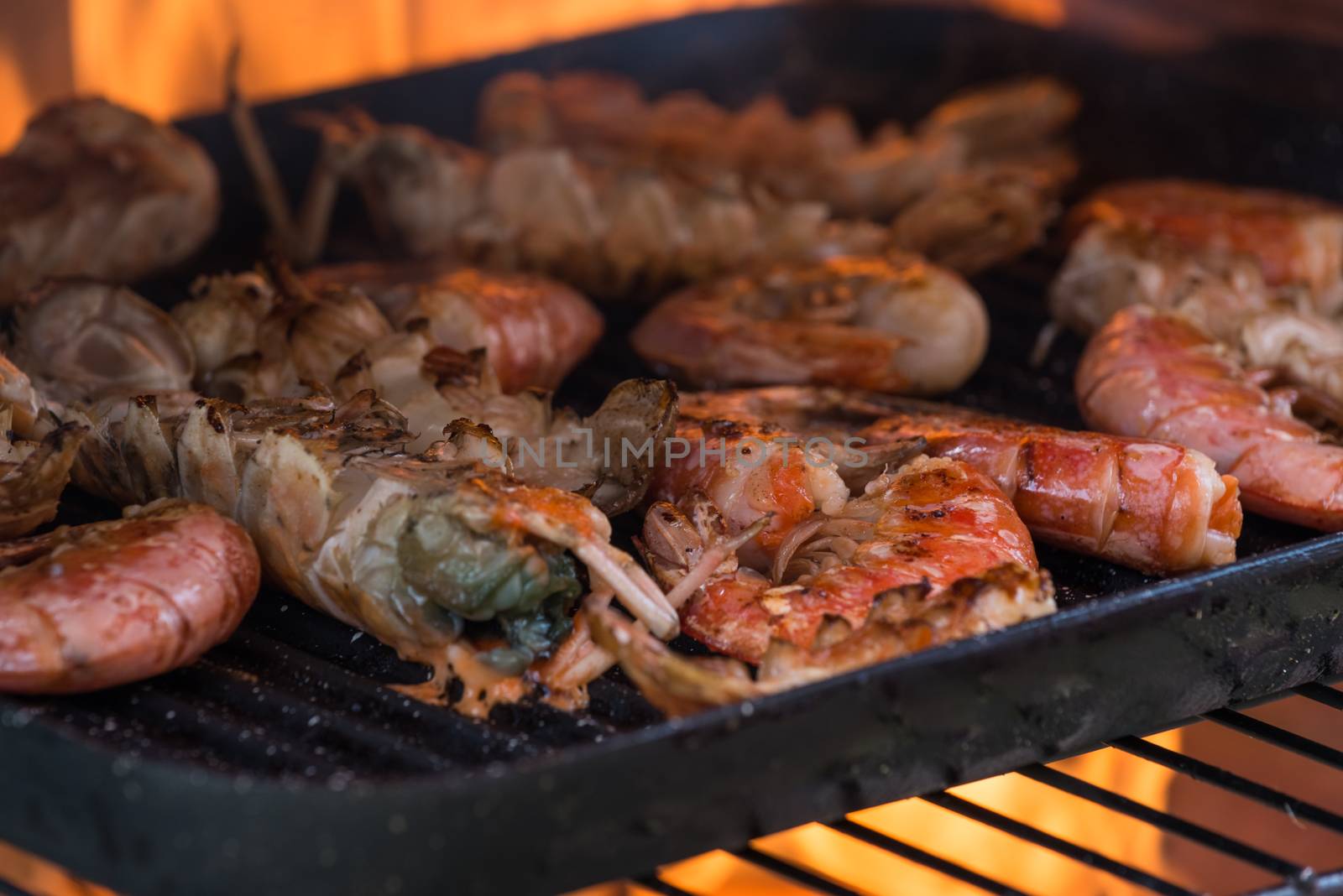 In the photo cooking  of shrimp grilled in a fireplace.