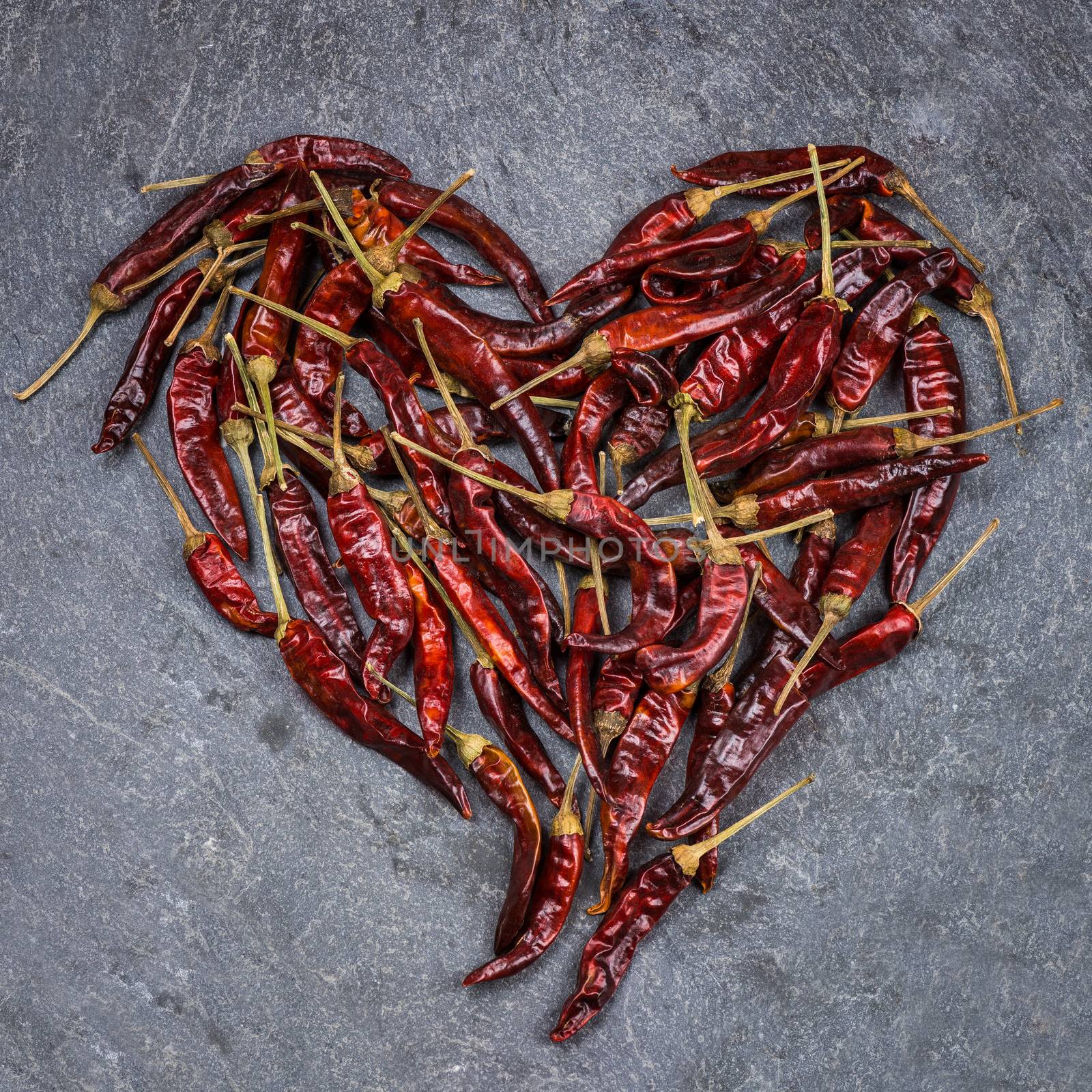 In the picture Italian chili peppers , arranged to form a red heart .