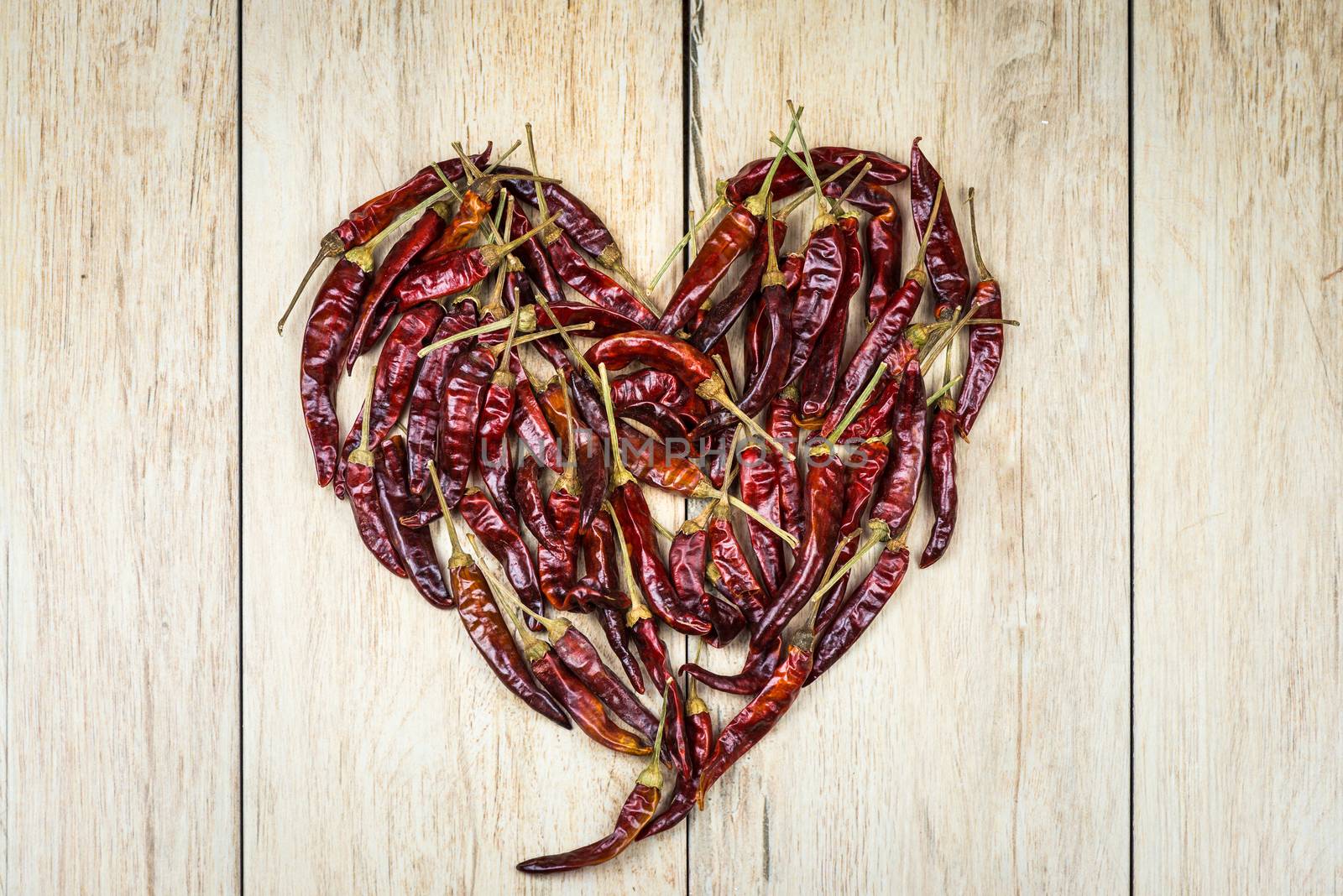 In the picture Italian chili peppers, arranged to form a red heart .