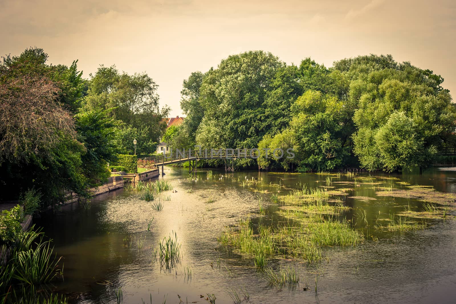 Idyllic countryside lake with a small bridge