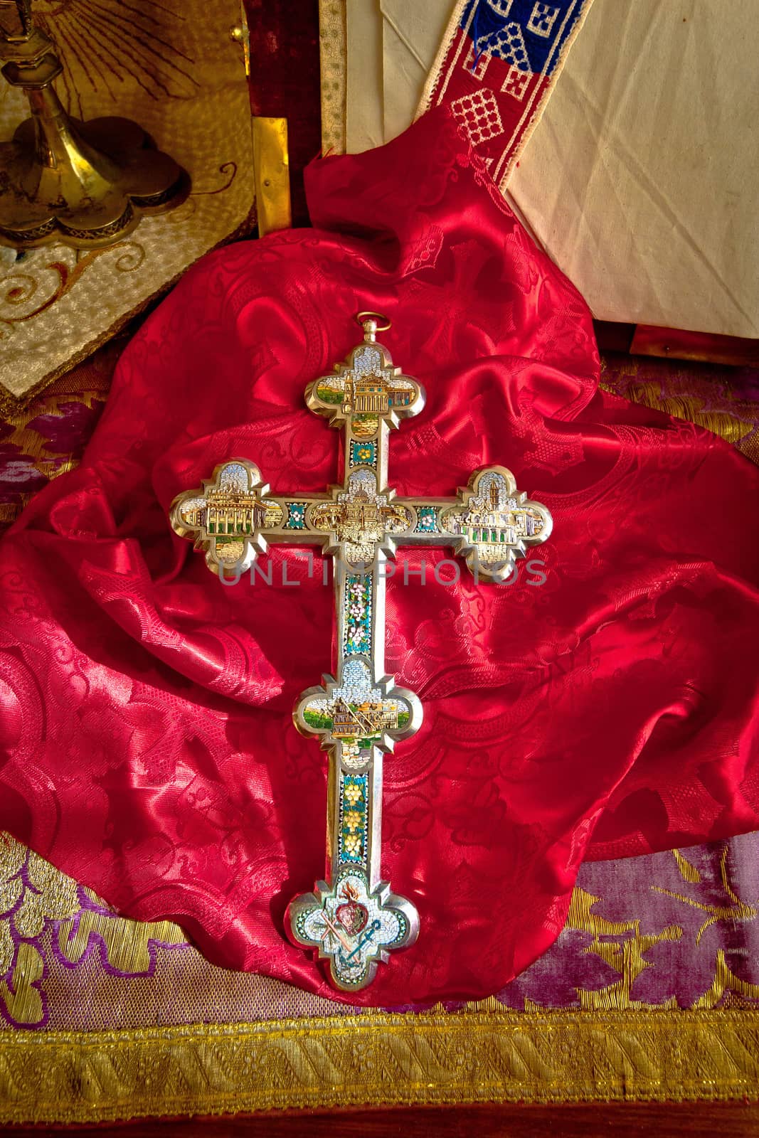 Golden catholic cross on red cloth by xbrchx