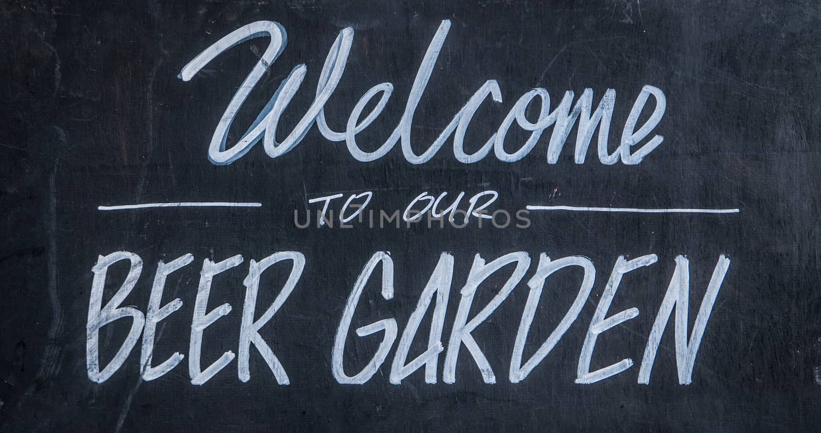 A Blackboard Sign Outside A Bar Or Pub Saying Welcome To Our Beer Garden