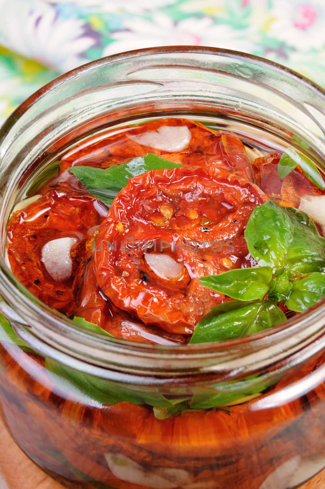 Slices of dried tomatoes with garlic and basil oil