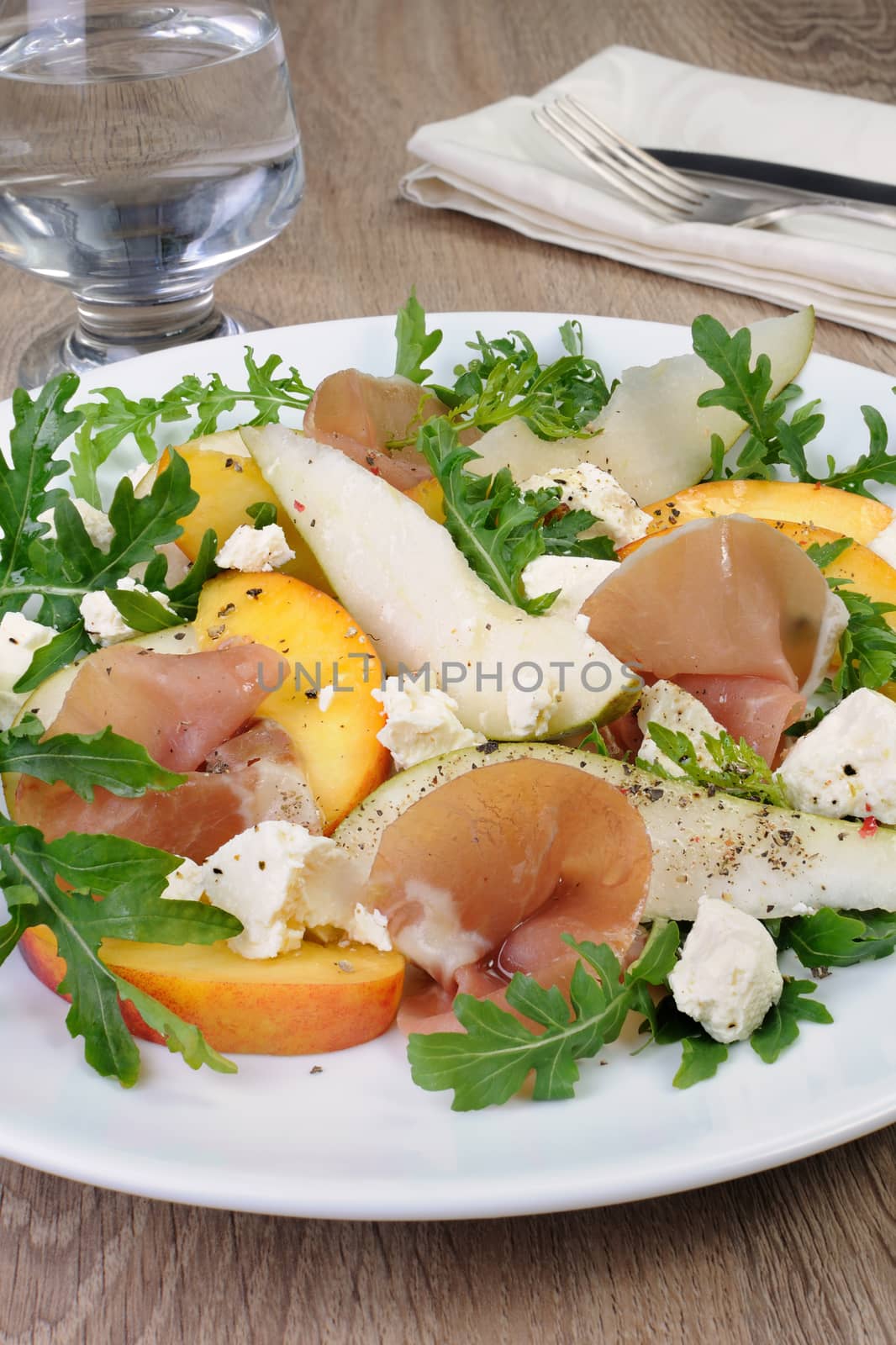 Light salad of pear, peach and ham, feta, arugula