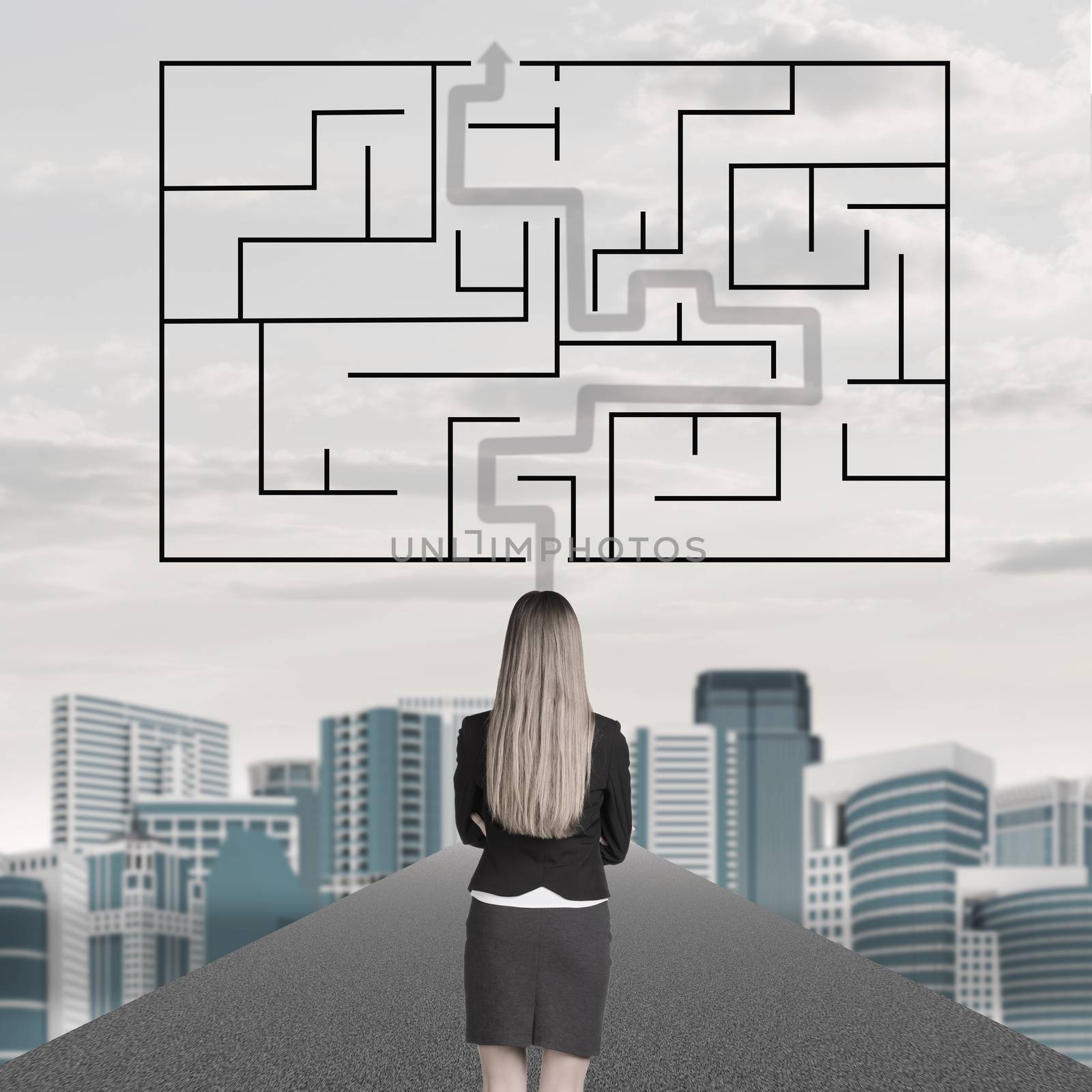Businesswoman with labyrinth and cityscape background, back view