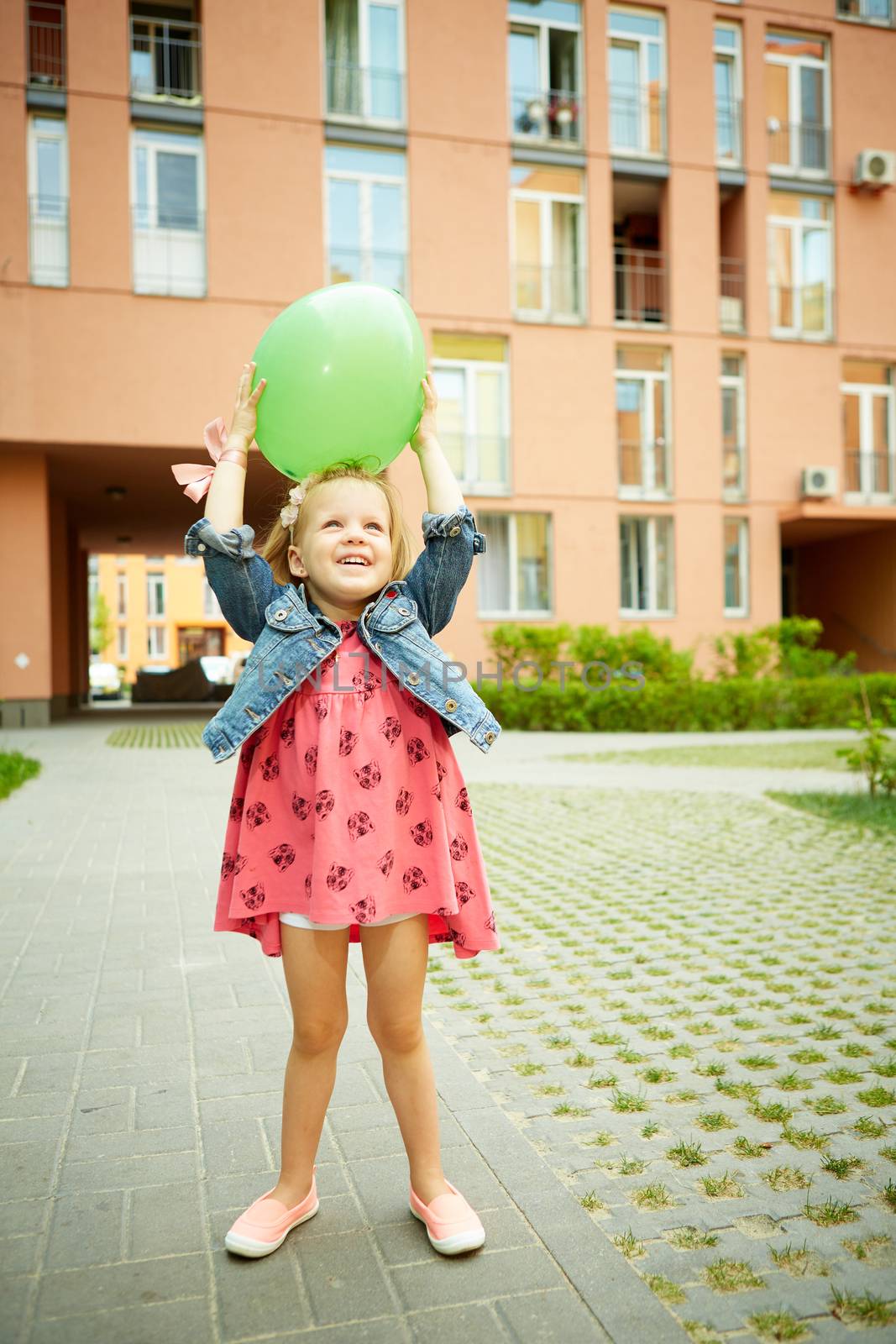 Portrait of funny little child, adorable blonde toddler girl outdoors
