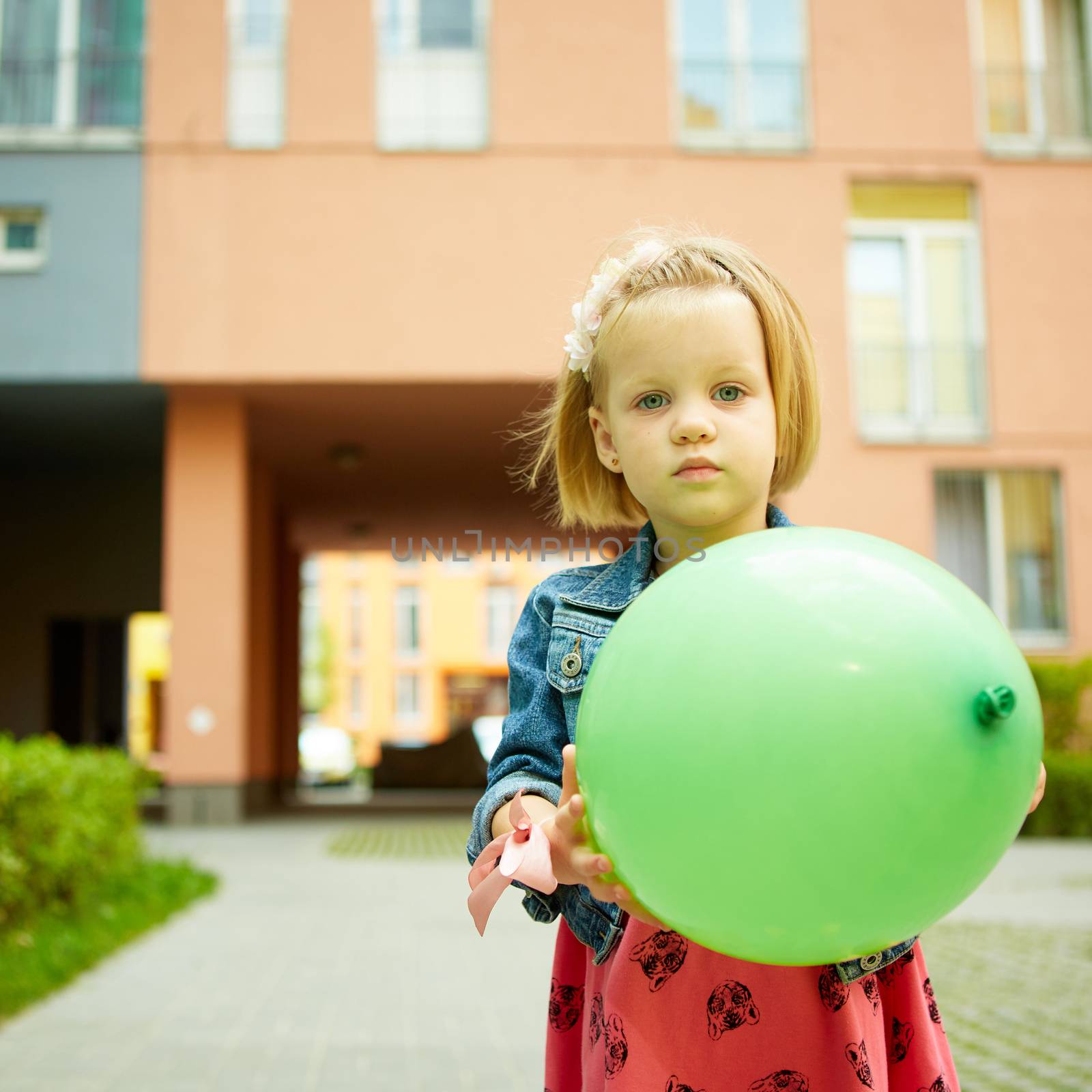 Portrait of funny little child, adorable blonde toddler girl outdoors