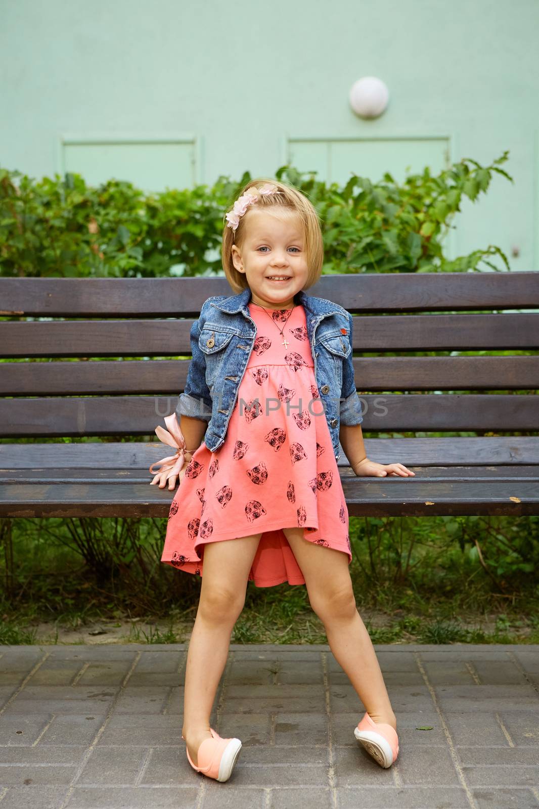Portrait of funny little child, adorable blonde toddler girl outdoors