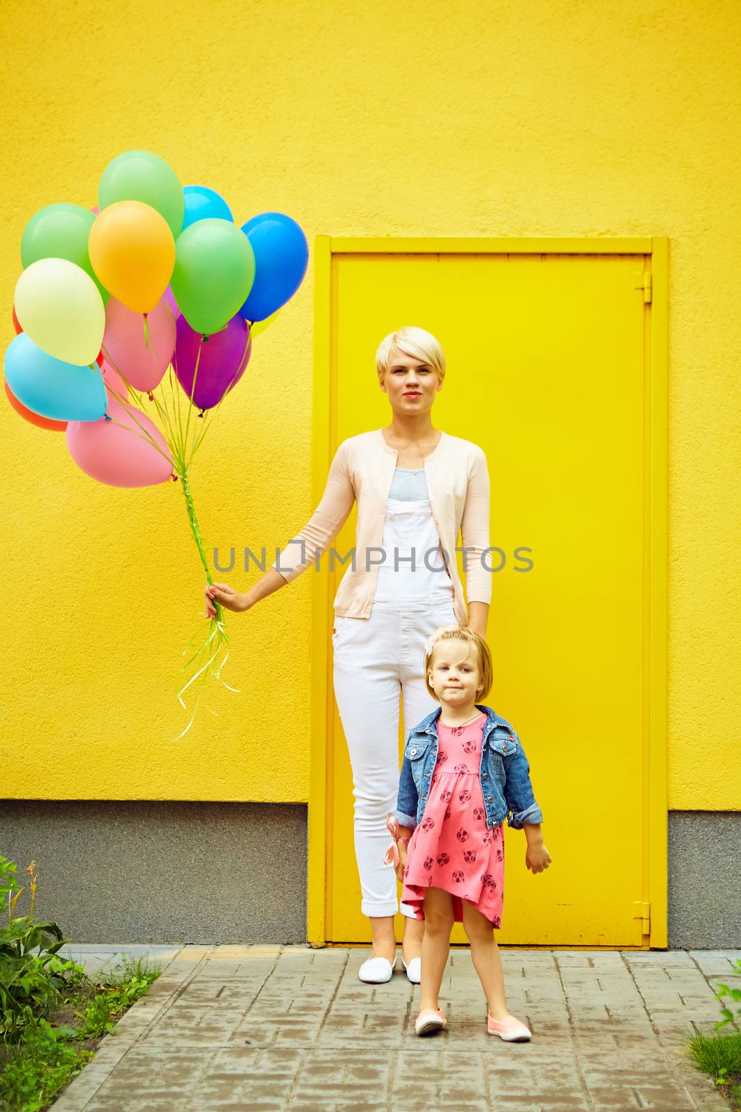 mother and child with colorful balloons  by sarymsakov
