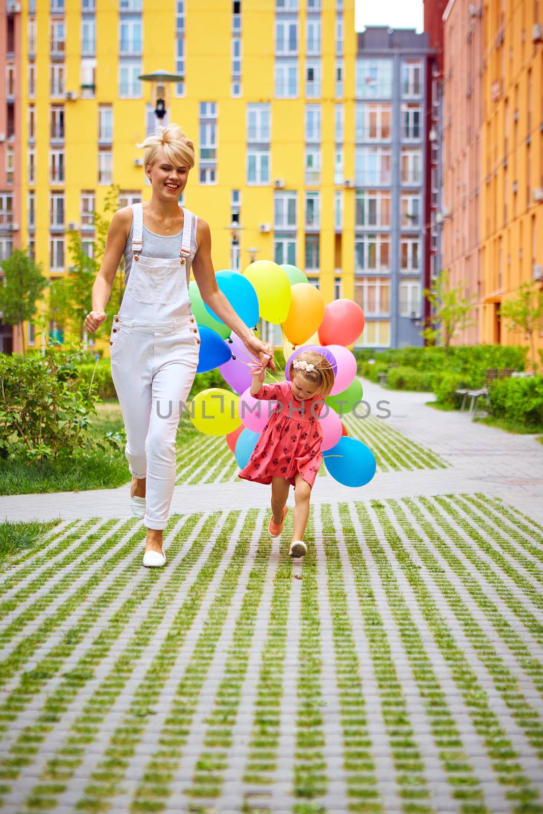 mother and child with colorful balloons by sarymsakov