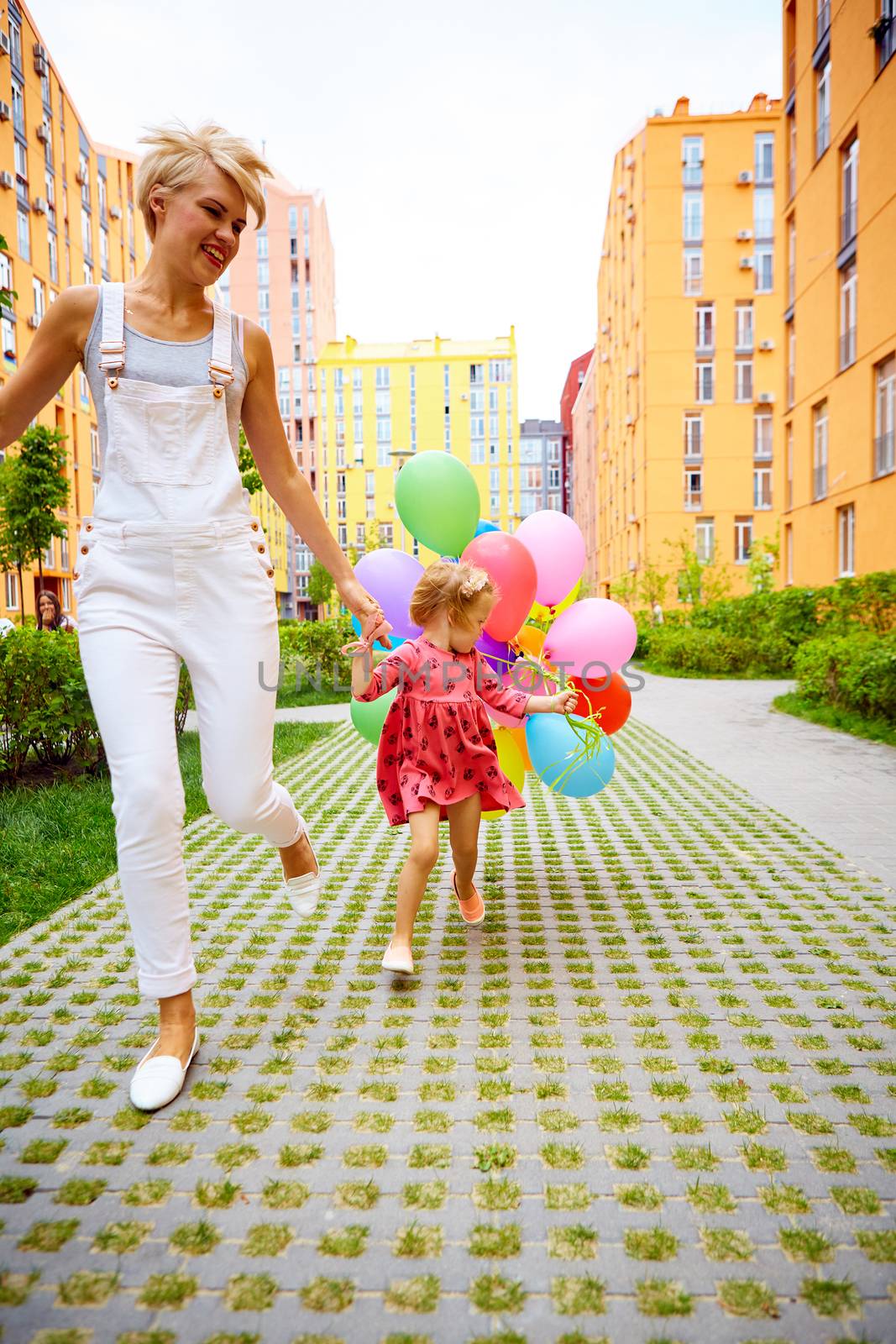 summer holidays, celebration, family, children and people concept - mother and child with colorful balloons