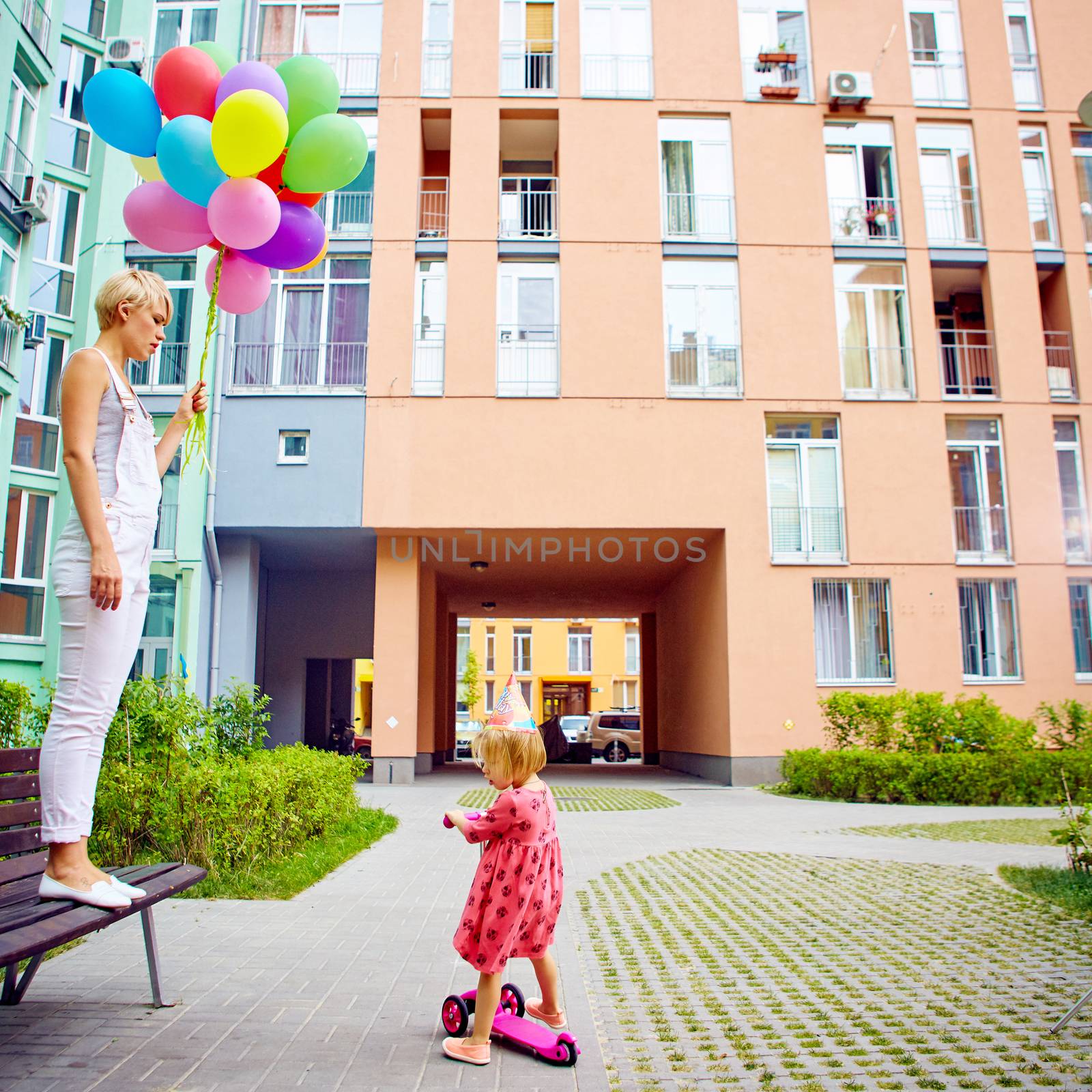 summer holidays, celebration, family, children and people concept - mother and child with colorful balloons