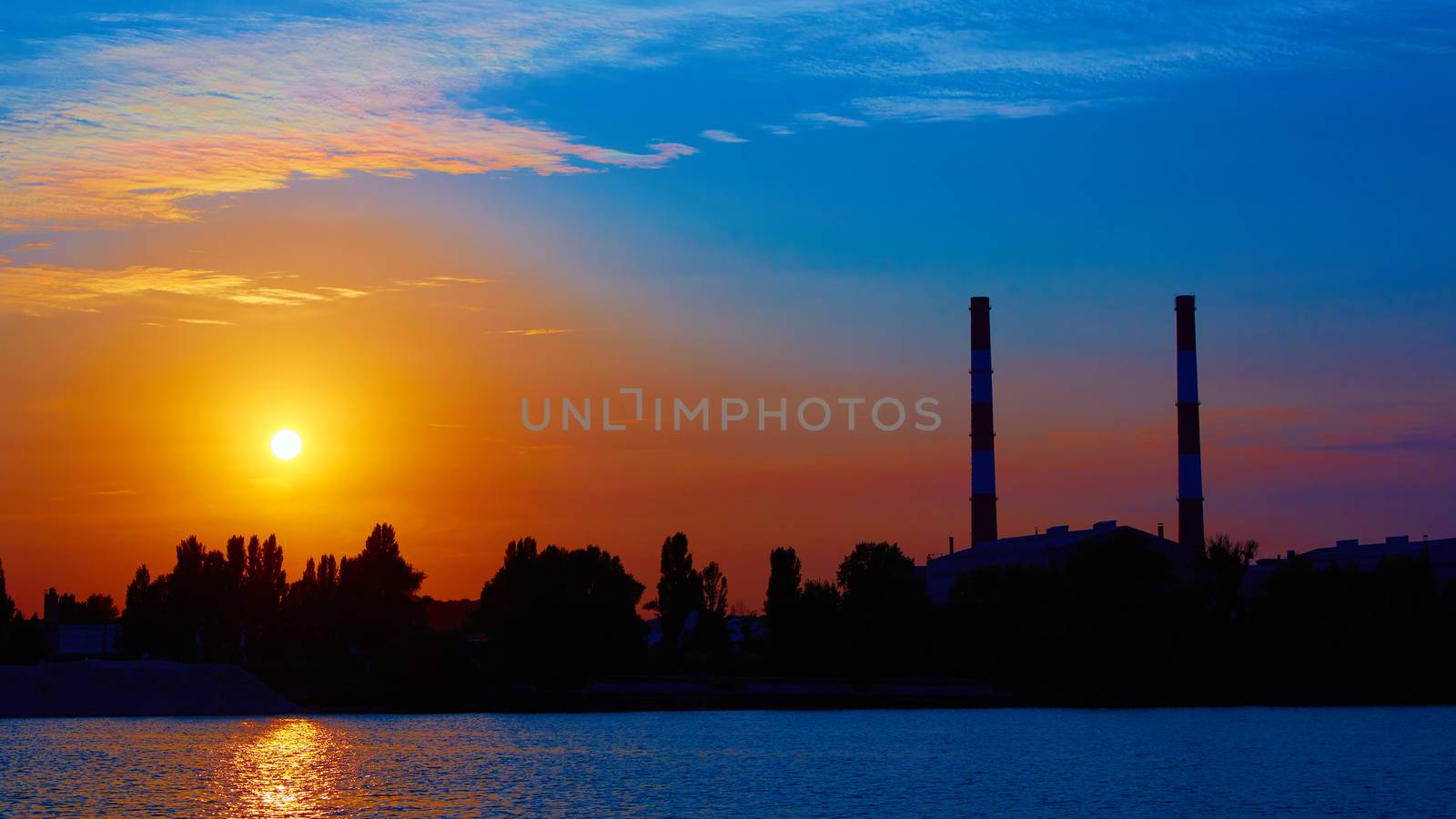 factory in silhouette and sunrise sky by sarymsakov