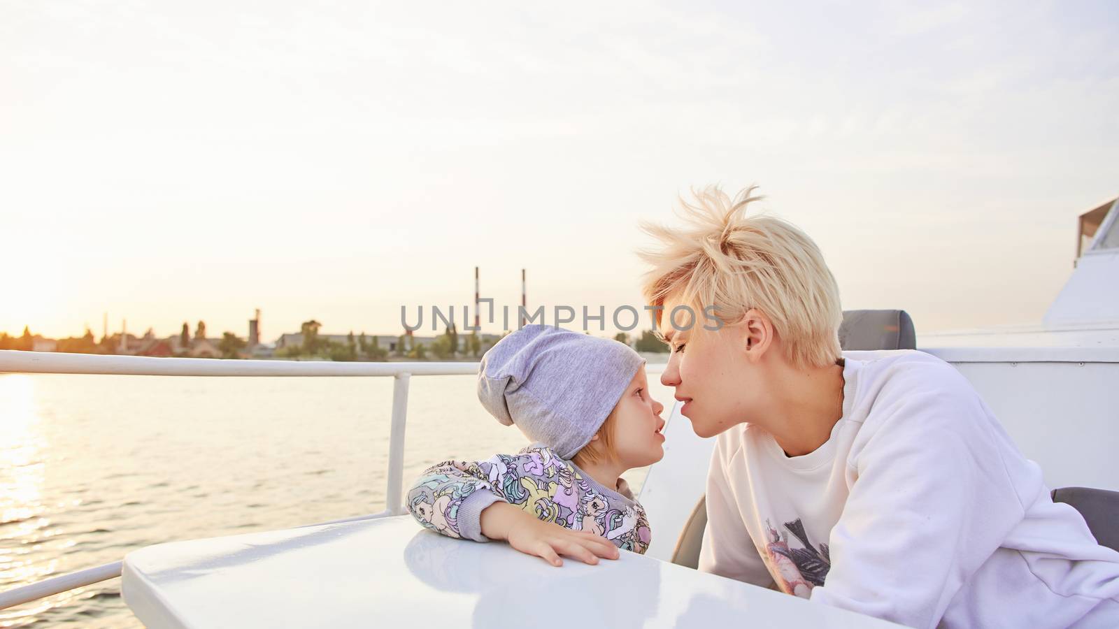 Mother, daughter on yacht or catamaran boat by sarymsakov