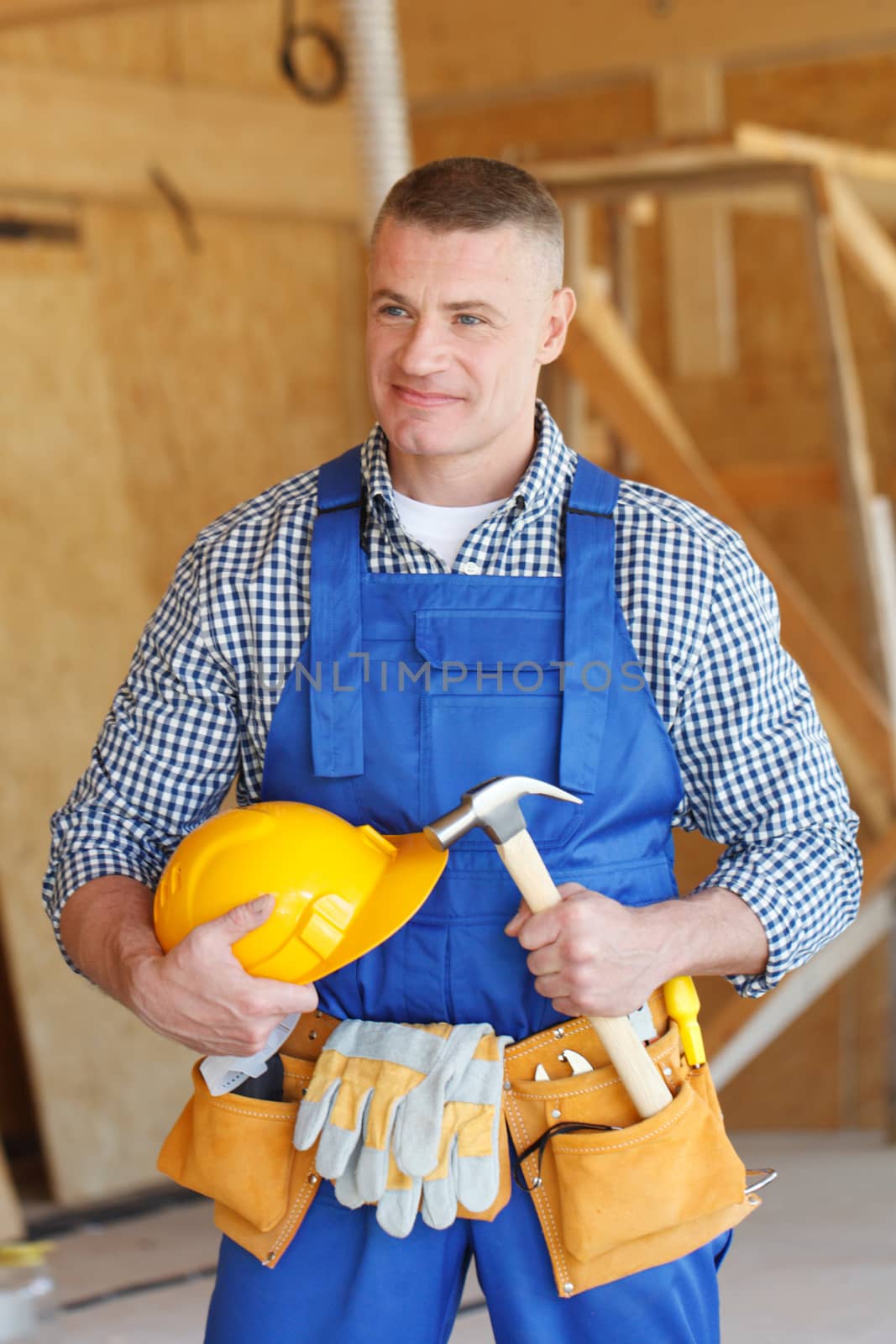 portrait of workman with hammer and helmet