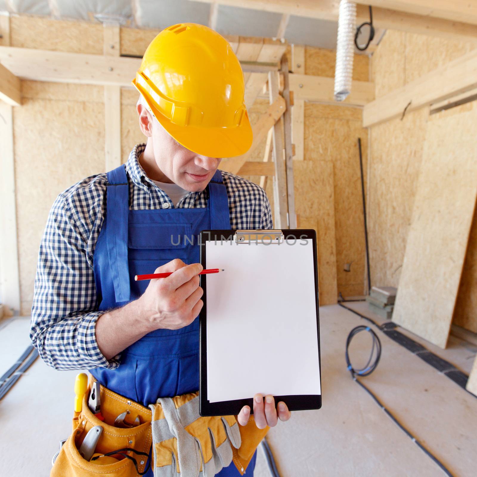 portrait of foreman pointing at white folder plate