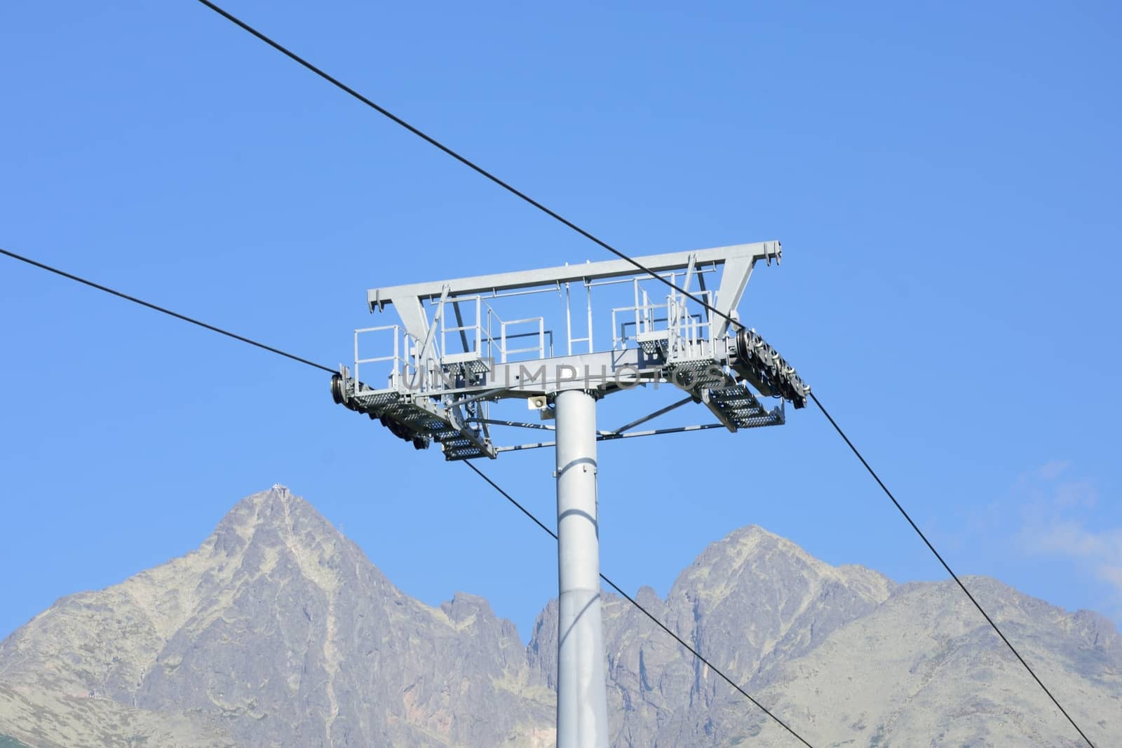 Chair lift mechanism with mountain in background
