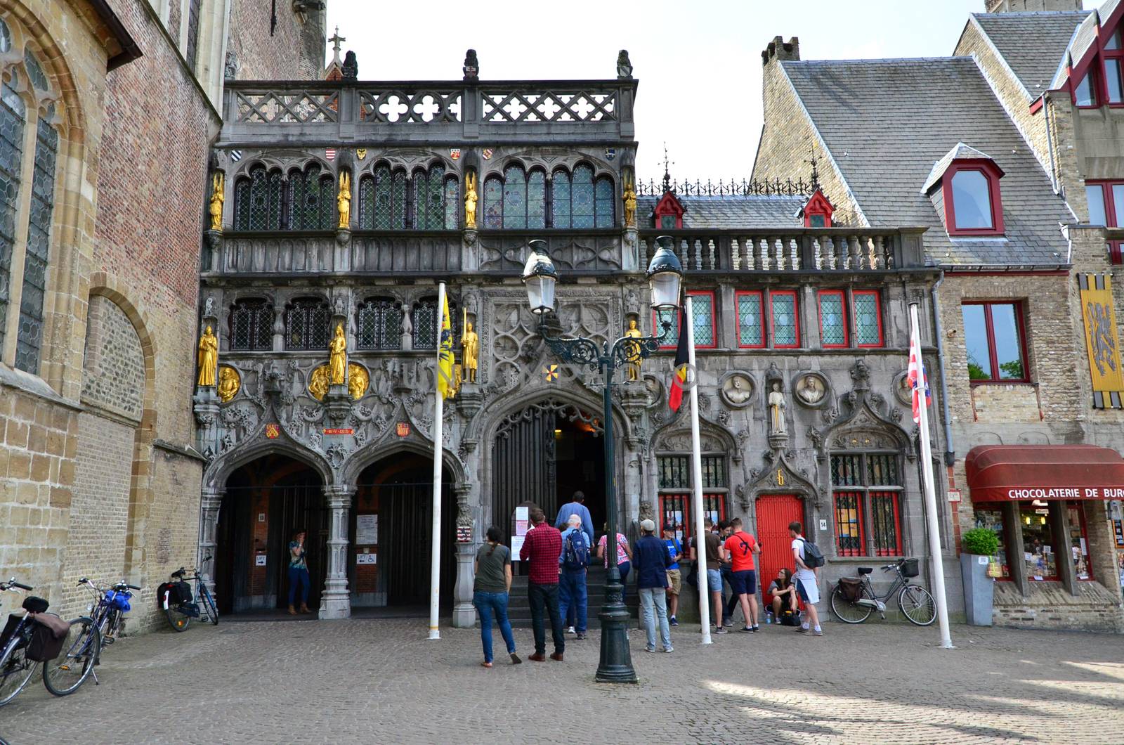 Bruges, Belgium - May 11, 2015: Tourist visit Basilica of the Holy Blood in Bruges, Belgium on May 11, 2015. Basilica is located in the Burg square and consists of a lower and upper chapel.
