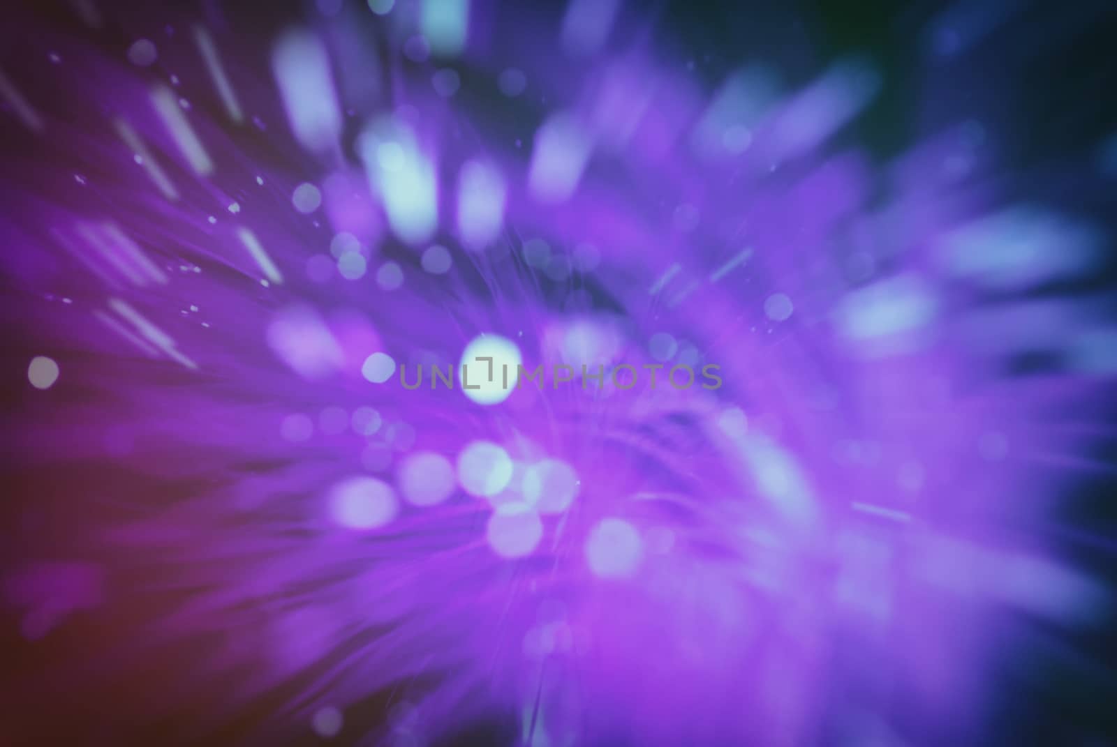 colored particles fly in space of the optical fiber and circling ( abstract blur background  )