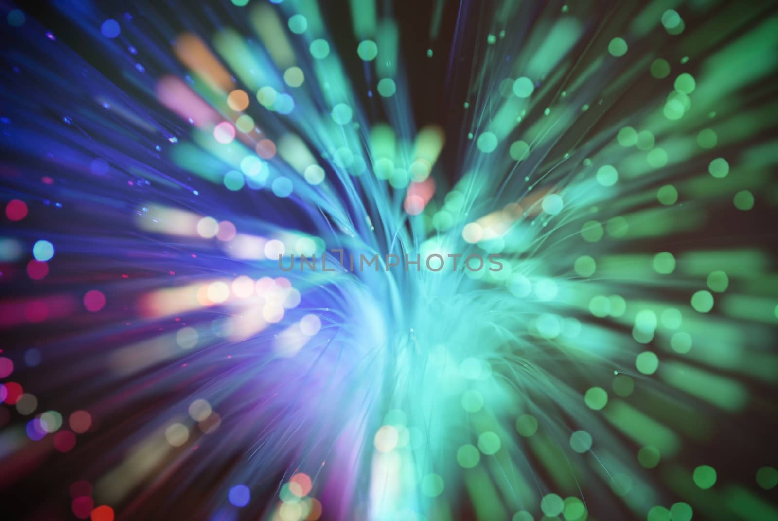 colored particles fly in space of the optical fiber and circling ( abstract blur background  )