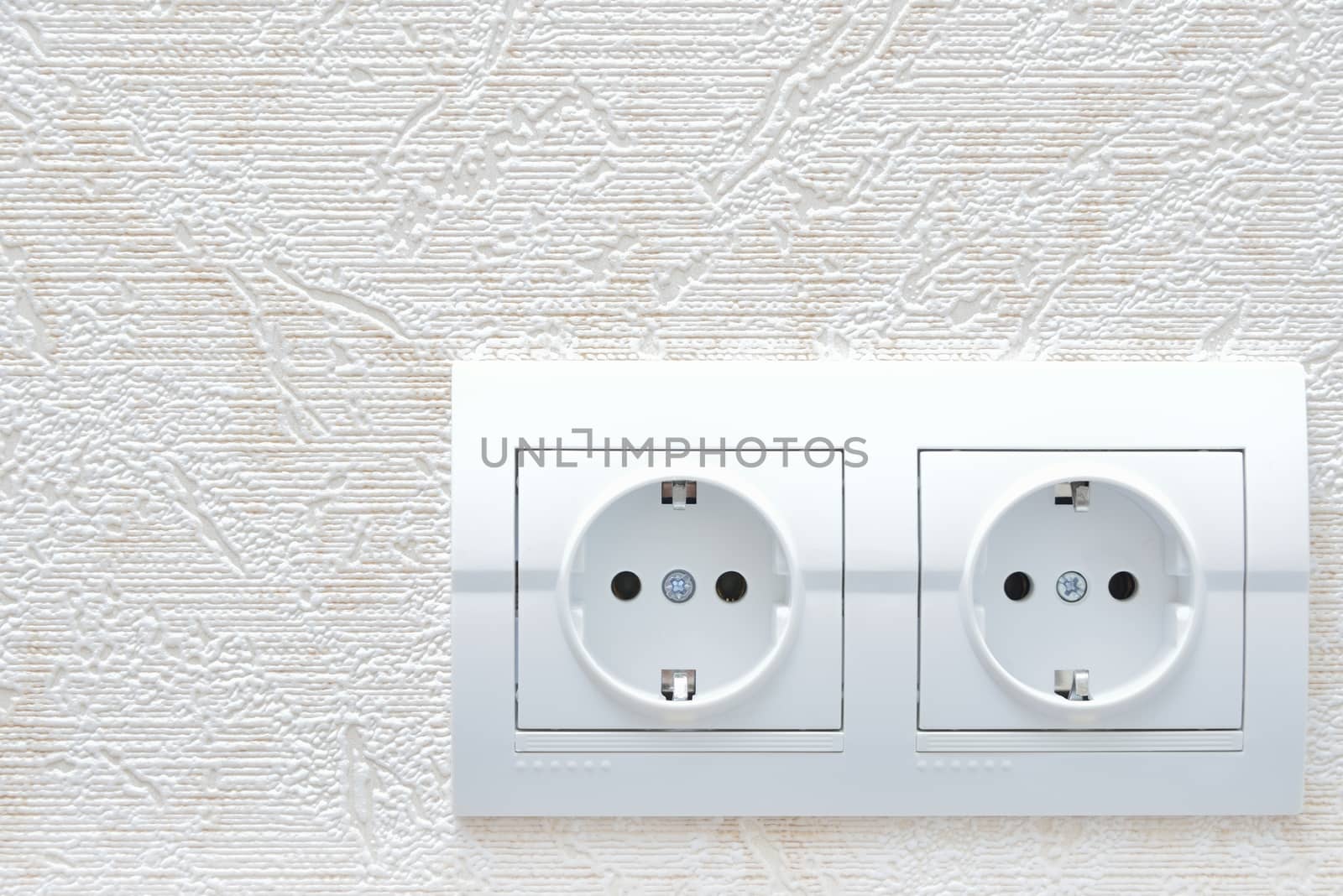 two white new electrical sockets (rosette) on wall