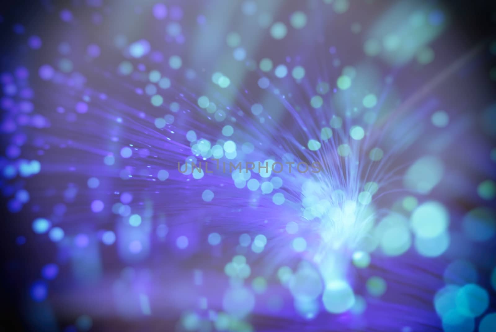 colored particles fly in space of the optical fiber and circling ( abstract blur background  )