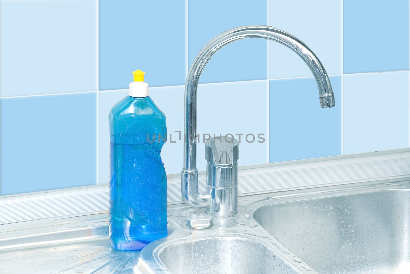 blue dish washer on kitchen with cleaner, tap, tile water drops