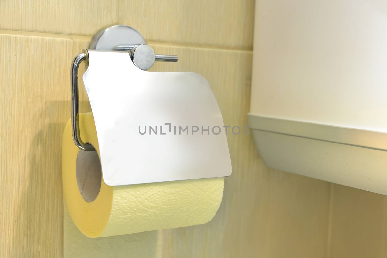 Toilet yellow paper and toilet paper holder.