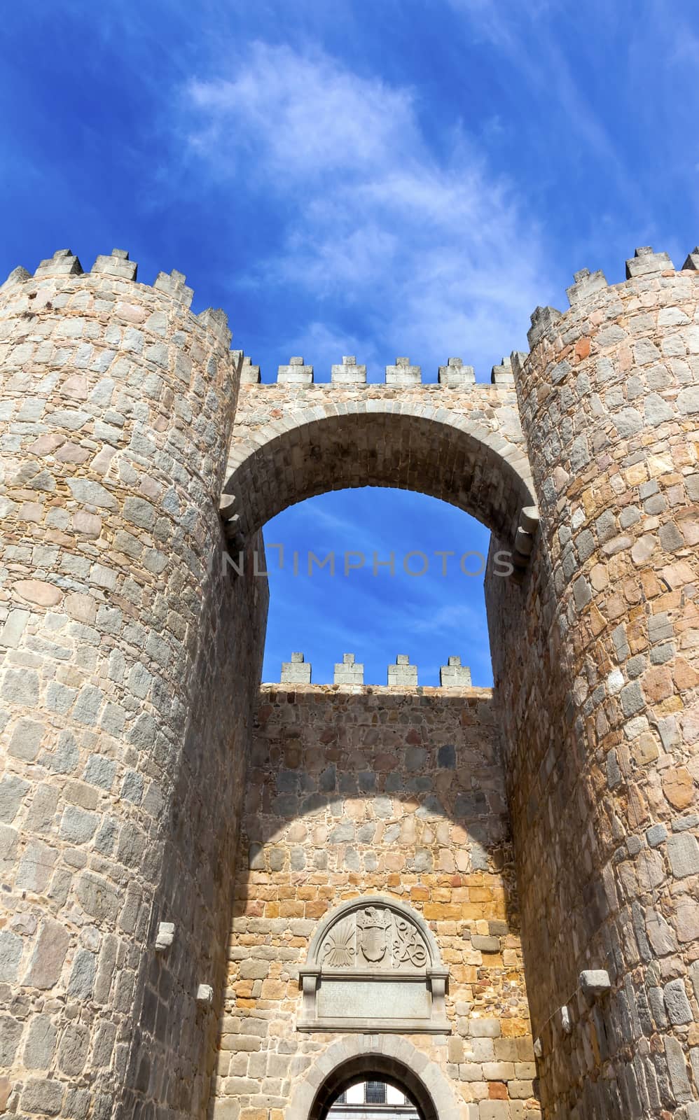 Castle Town Walls Arch Gate Avila Castile Spain.  Described as the most 16th century town in Spain.  Walls created in 1088 after Christians conquer and take the city from the Moors.  Public town, not a private castle.  