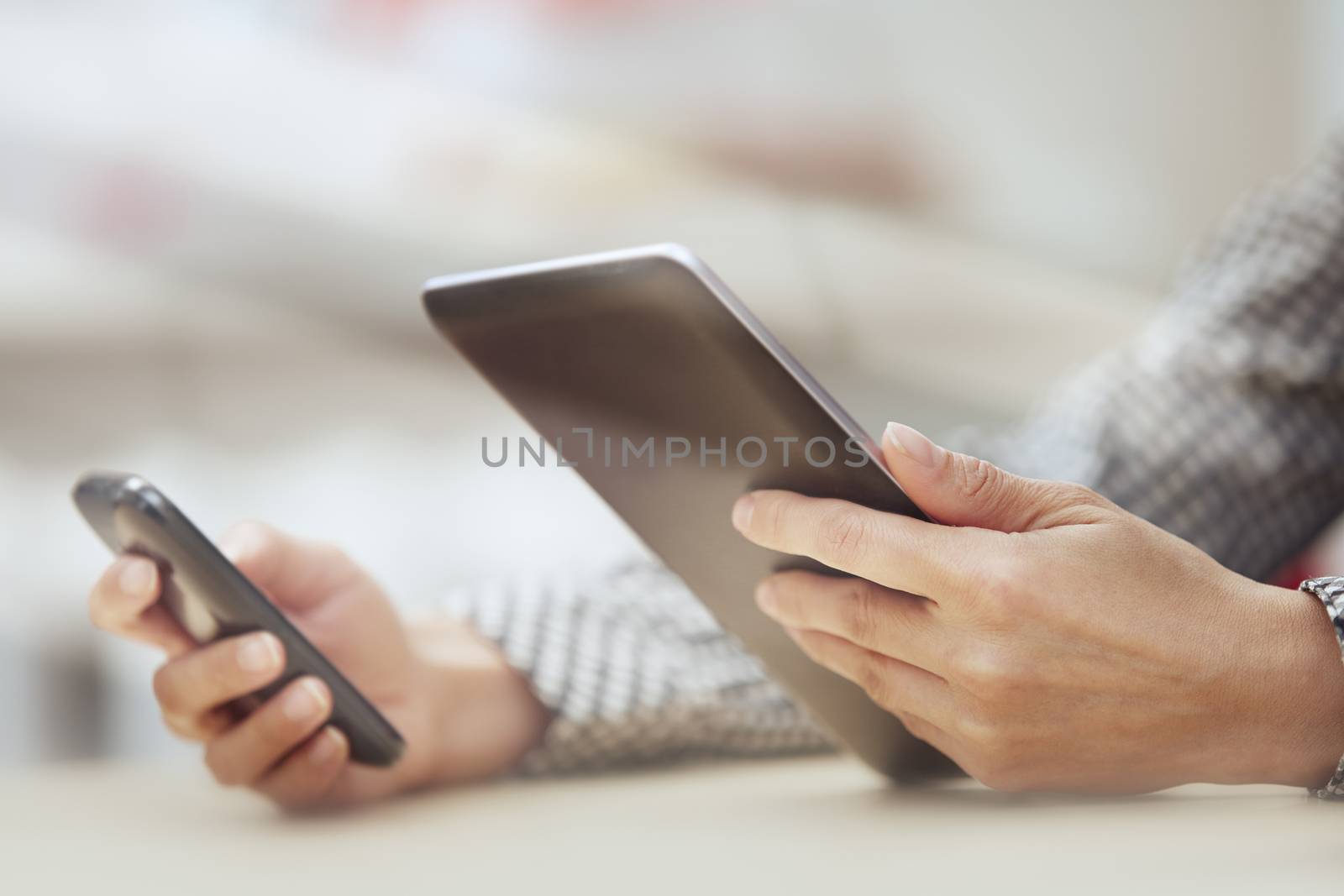 Businesswoman at office with digital tablet and smartphone