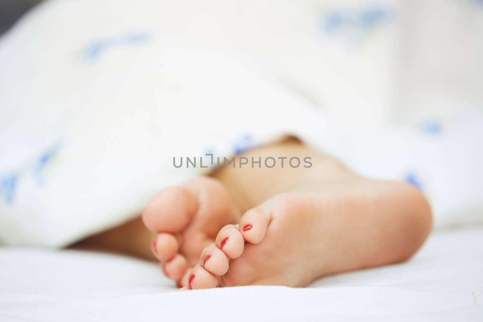 Feet of sleeping woman. Horizontal photo