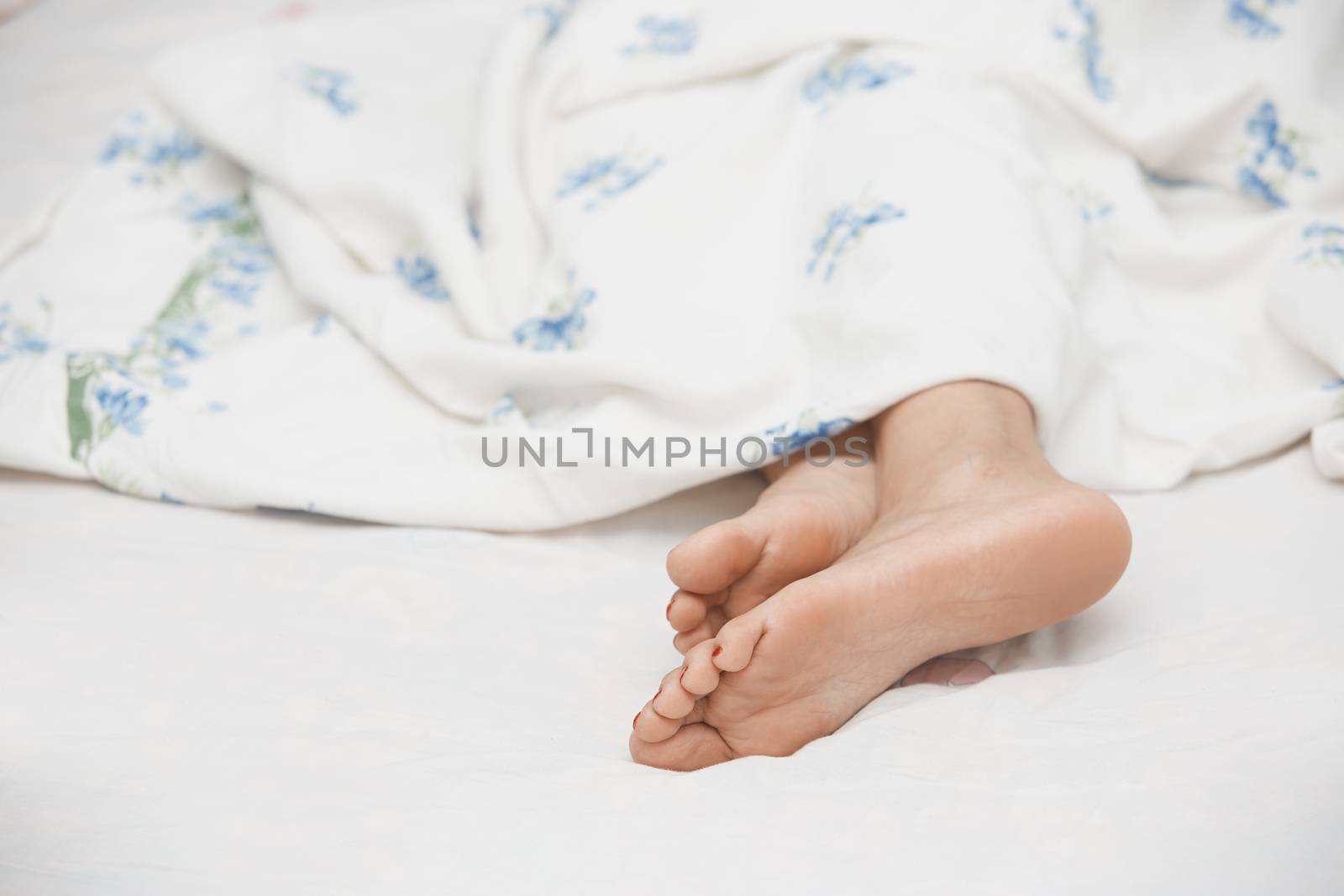 Feet of sleeping woman. Horizontal photo