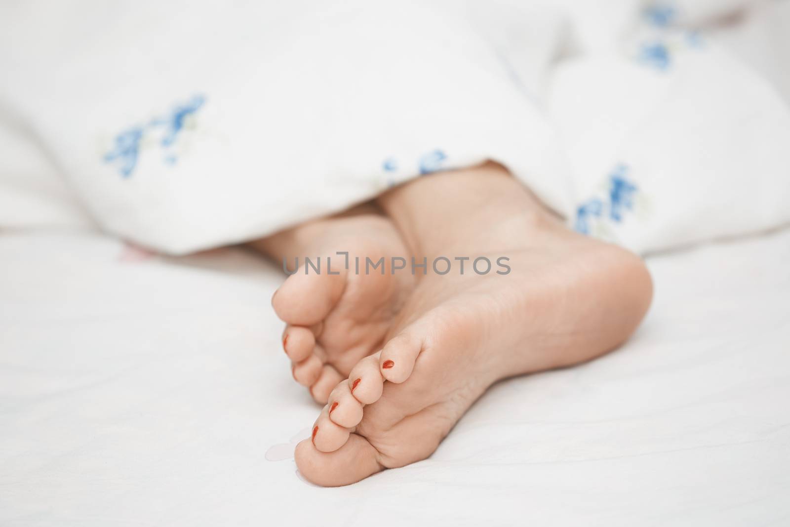 Feet of sleeping woman. Horizontal photo