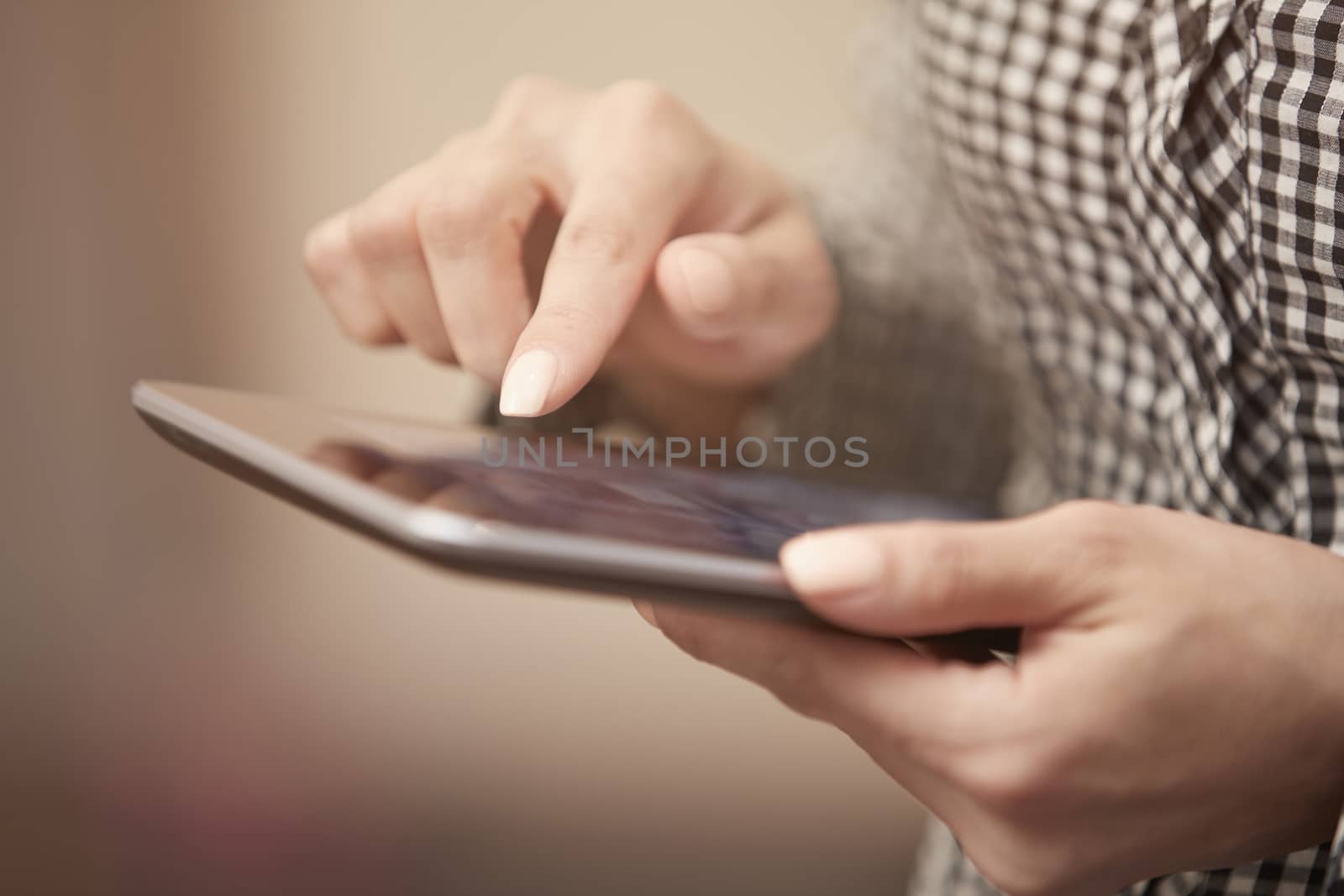 Hands of woman using digital tablet