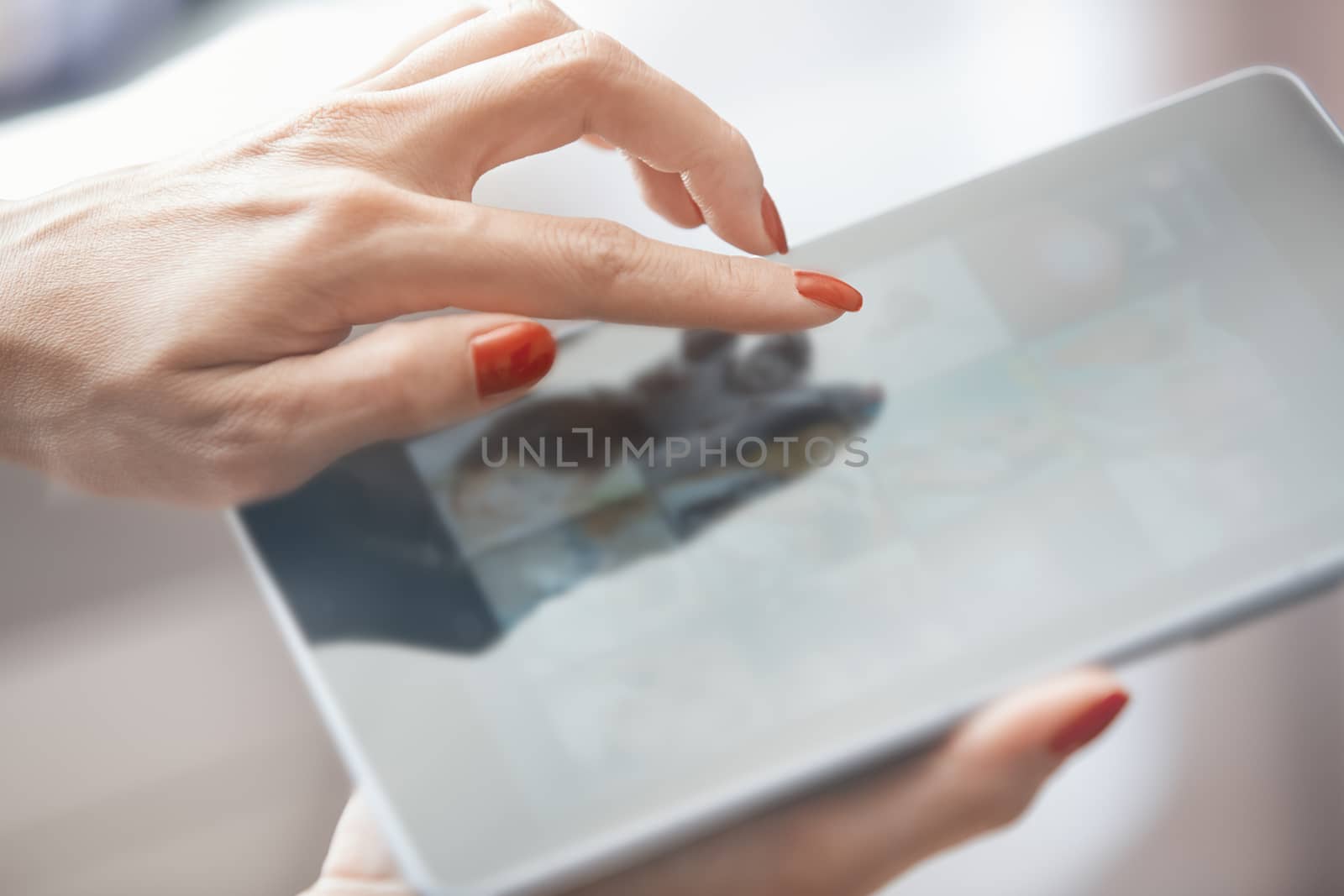 Hands of woman using digital tablet