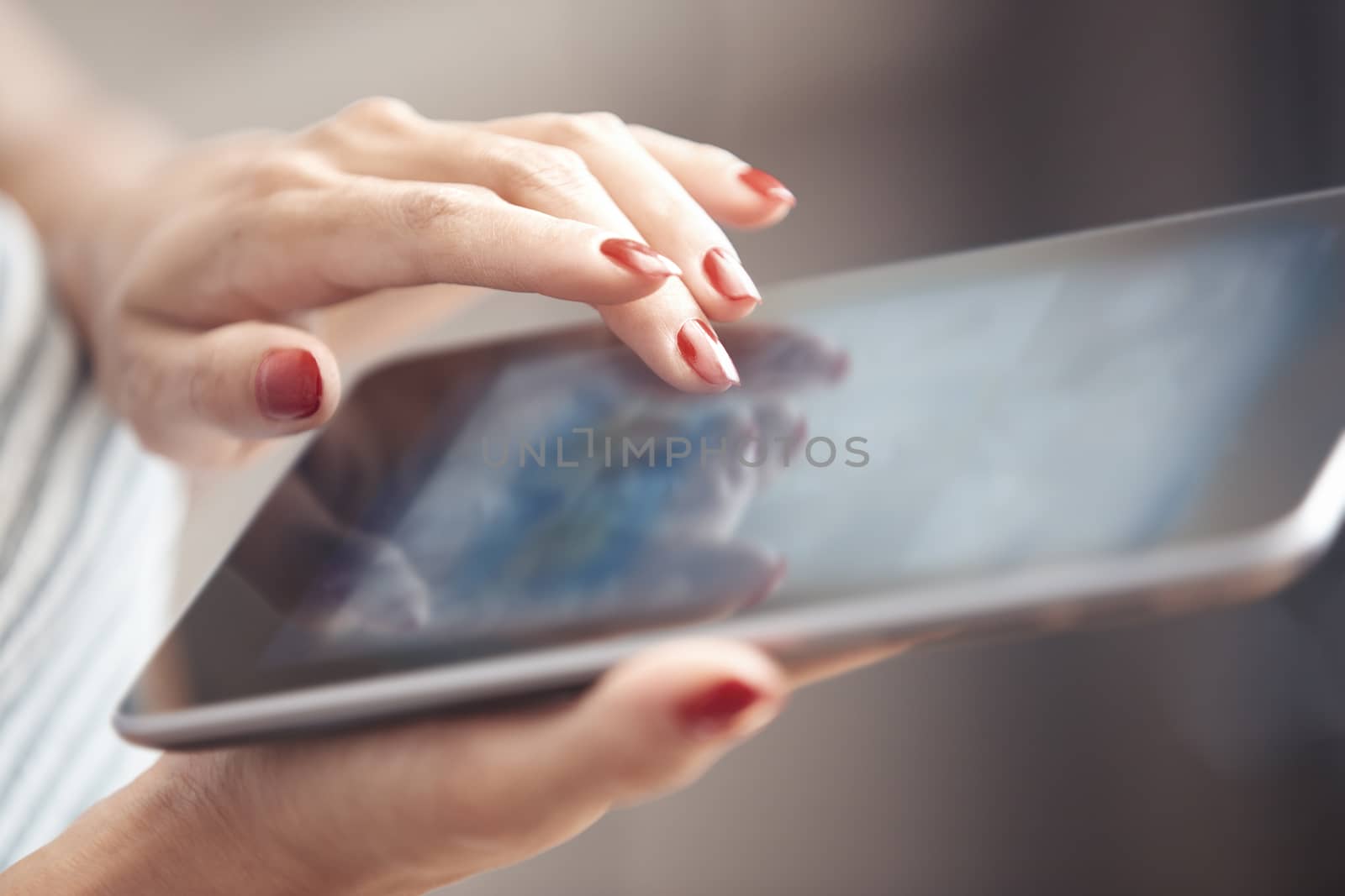 Hands of woman using digital tablet