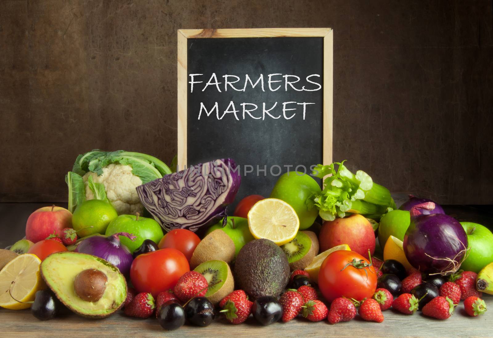 Fruits and vegetables around a chalkbaord with farmers market 