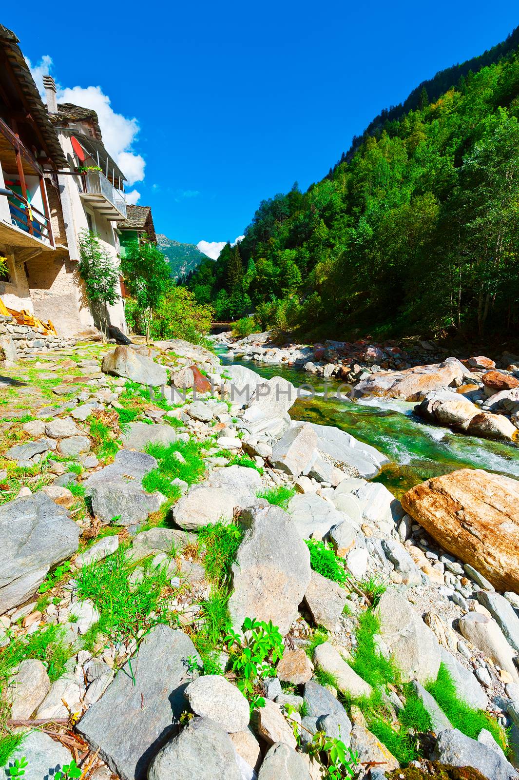 Medieval City on the Banks of a Mountain River in Italian Alps