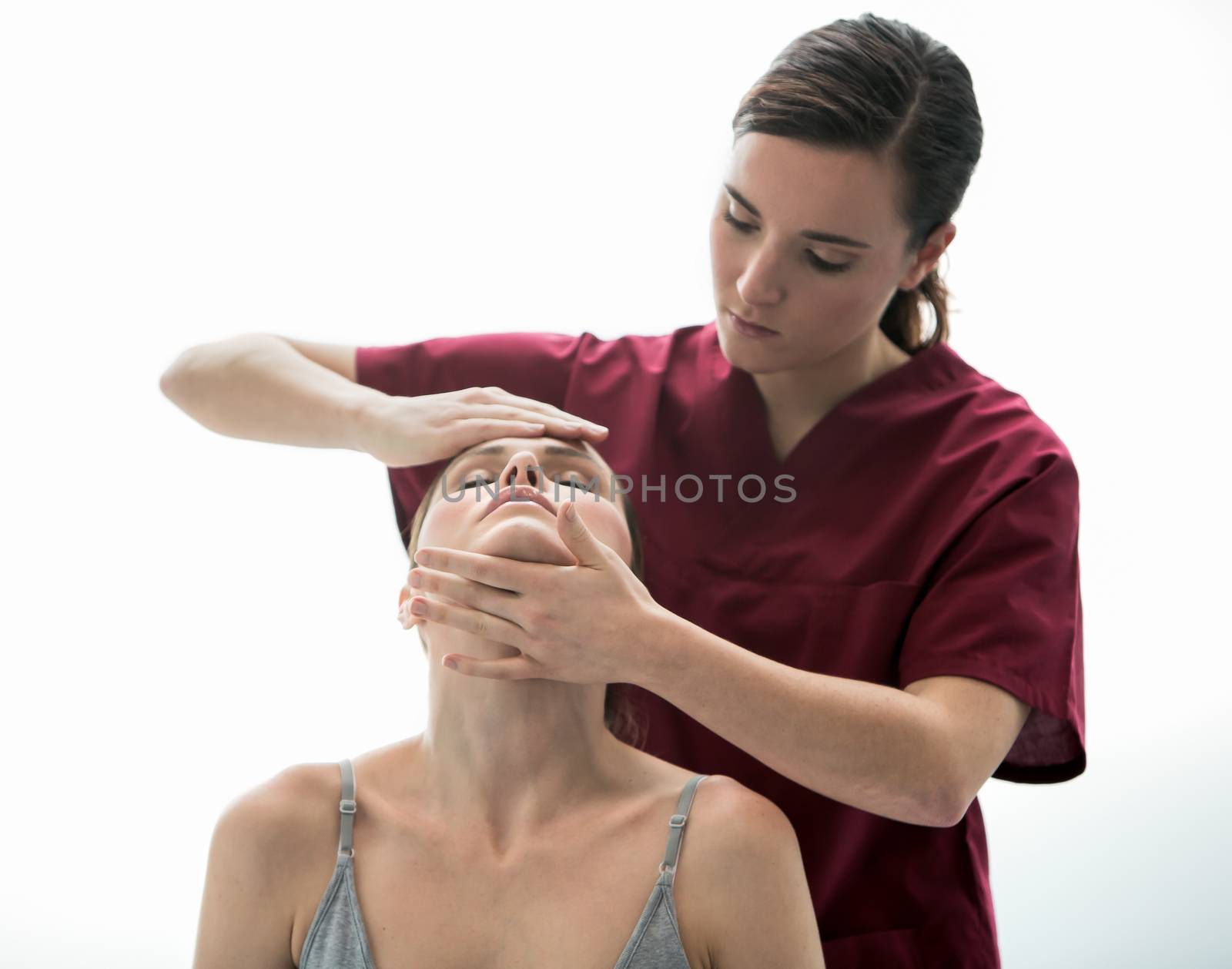 doctor evaluation woman neck by Flareimage