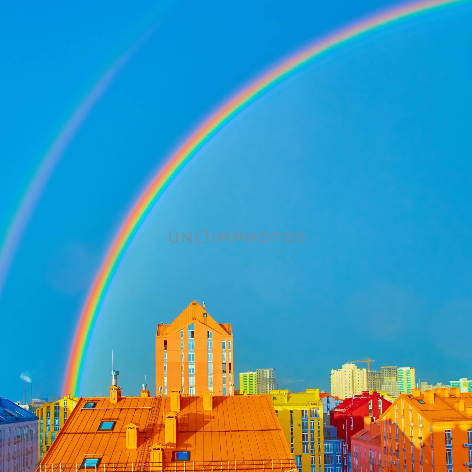 Double rainbow over bright colored houses. Kiev city