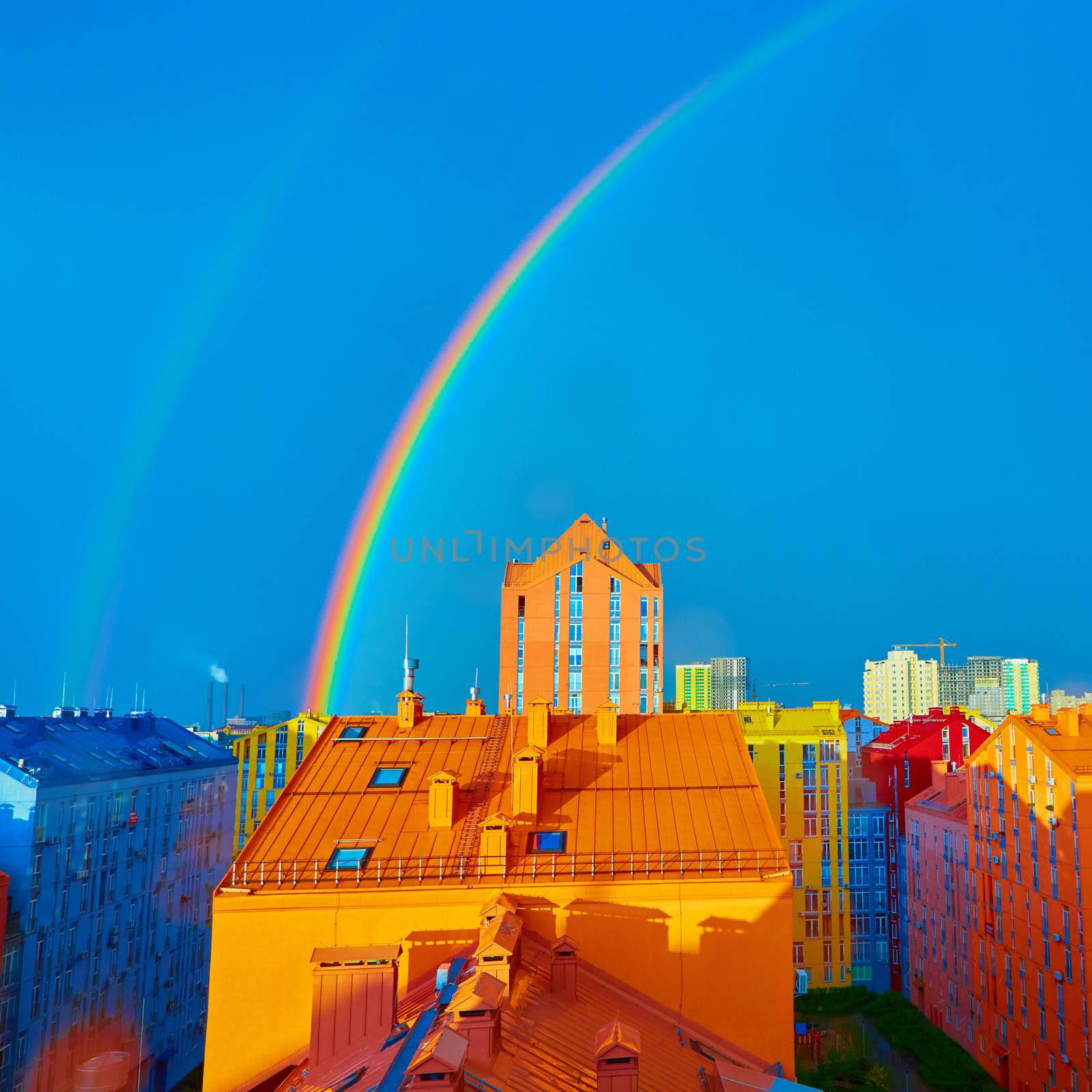 Double rainbow over bright colored houses. Kiev city