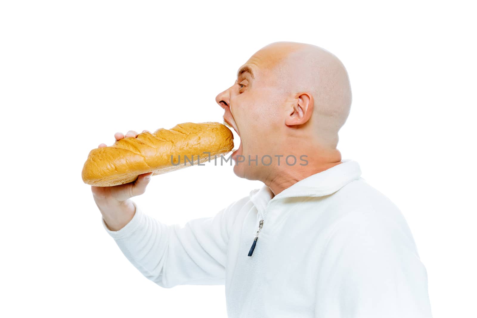 Bald man biting a loaf. Isolated on white. Profile