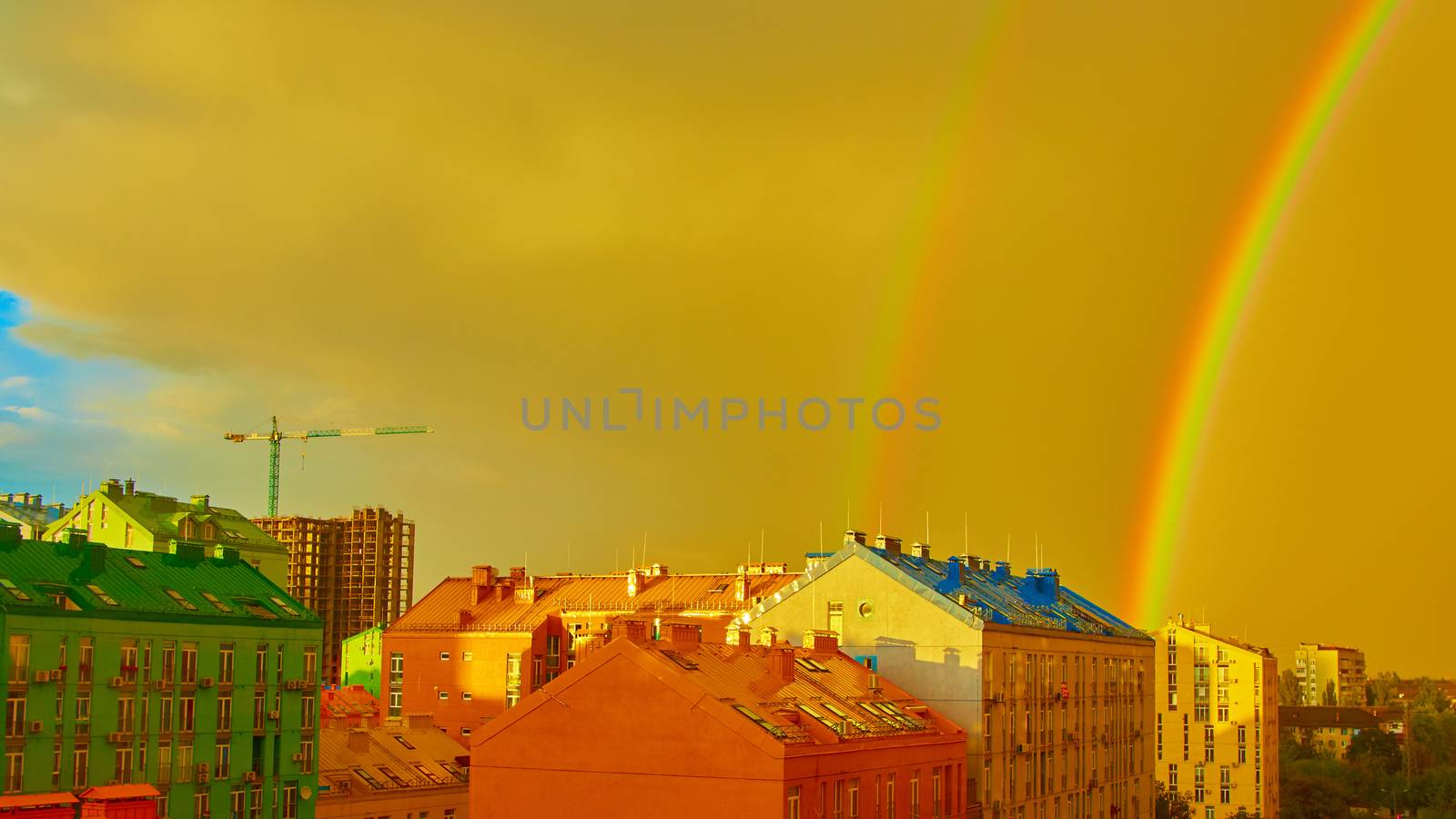 Double rainbow over bright colored houses. Kiev city