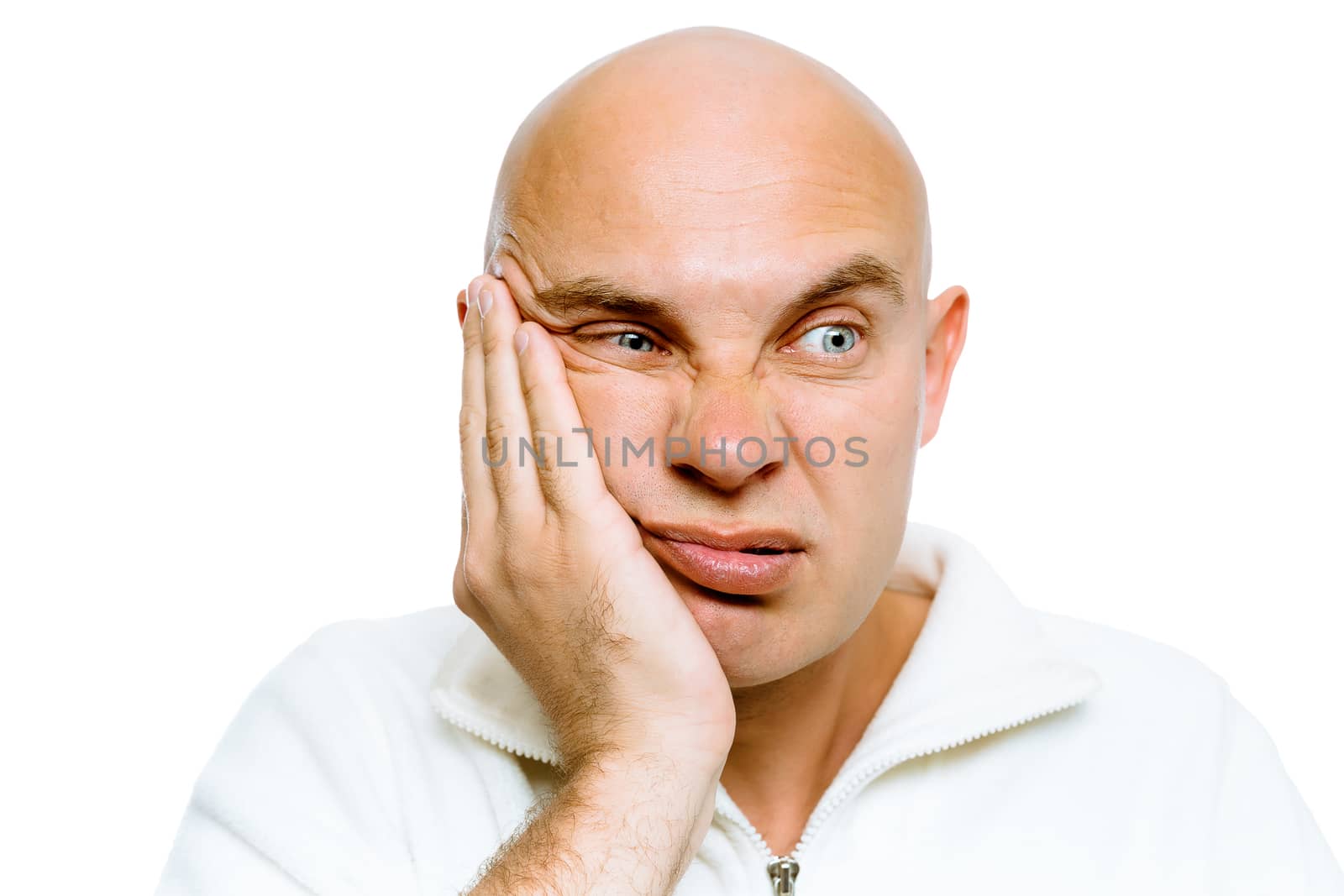 Bald man holding his hand to his cheek. Toothache or problem