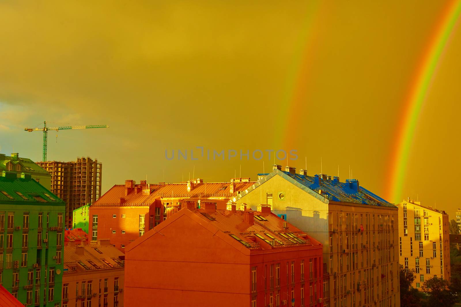 Double rainbow over bright colored houses. Kiev city