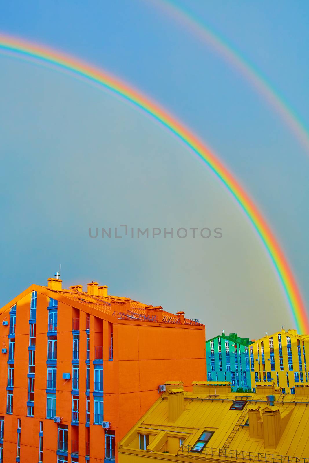 Double rainbow over bright colored houses. Kiev city